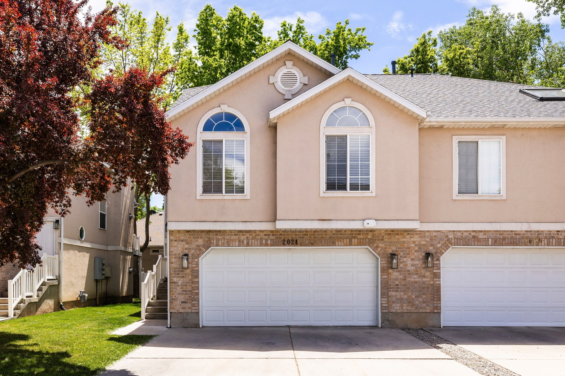 Ideally located within the Cottonwood Cove community, this desirable end-unit townhome offers comfortable, low-maintenance living just moments from Holladay's popular Half Mile district and the area's vibrant dining, shopping, and everyday amenities. The thoughtfully designed main living space features vaulted ceilings and an open-concept layout that seamlessly connects the kitchen and living area, where a gas fireplace creates a warm and inviting focal point for both relaxing and entertaining. The kitchen offers generous cabinetry and counter space, along with bar seating for two. The vaulted primary suite provides a spacious retreat complete with a walk-in closet, double vanity and jetted soaking tub. A secondary bedroom, three-quarter bathroom and a conveniently located laundry closet complete the main level. The walkout lower level expands the home's living space with an additional family room that opens out to a private patio, an above-grade bedroom, three-quarter bathroom and a dedicated storage room. A two-car attached garage offers ample space for recreational equipment, storage and everyday convenience in this ideally situated Holladay residence.