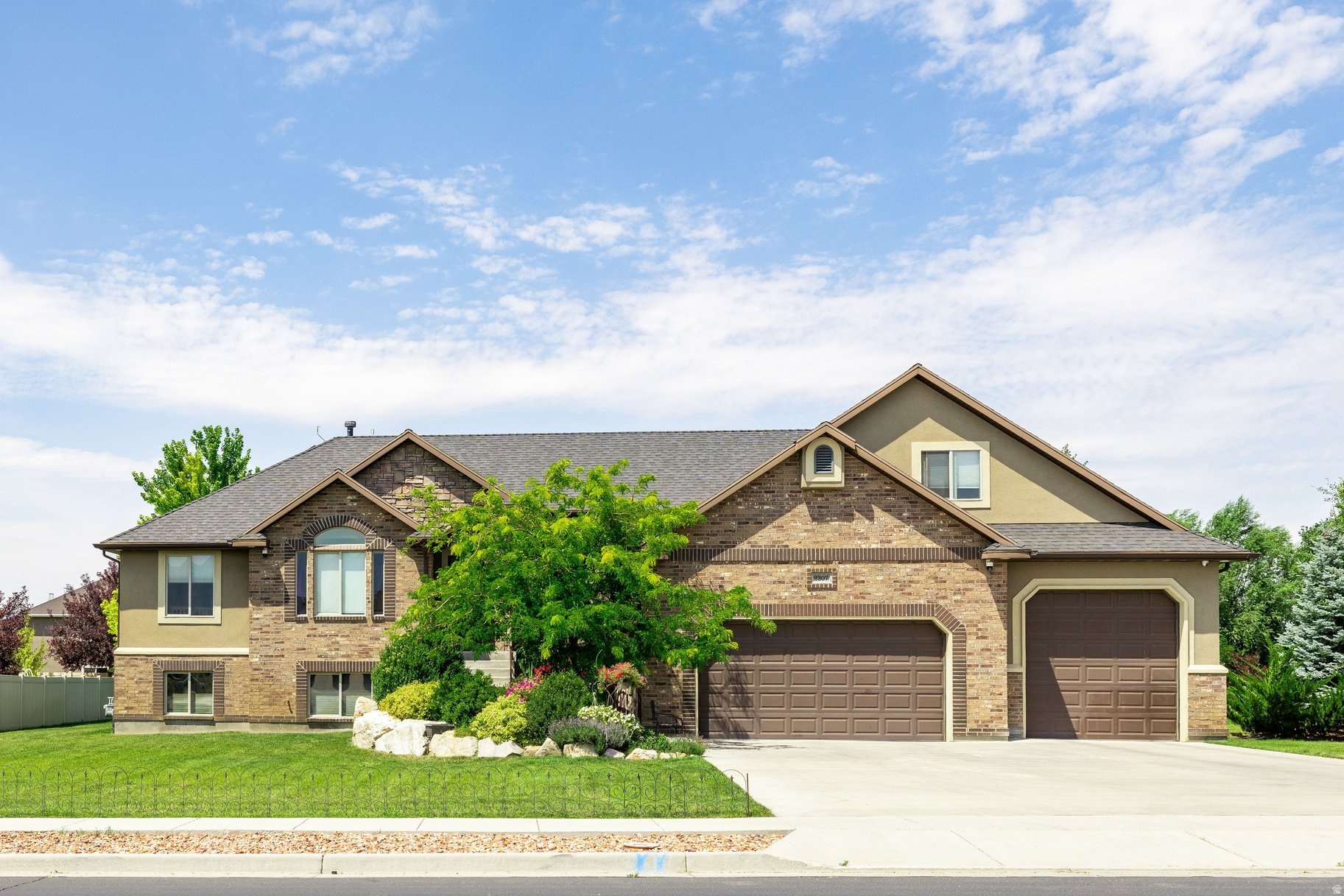 Meticulously maintained, move-in ready Spacious Luxury Rambler with Extra Parcel & Stunning Mountain Views! Get the best of both worlds-community and peaceful country living. Located just 20 minutes from HAFB, this beautifully designed 6-bedroom, 3.5-bath custom home was built in 2012. Situated on a fully landscaped and treed 0.45-acre lot, this property also includes an additional 0.41-acre adjoining parcel- with cabin onsite offering incredible potential.  Inside, you'll find a thoughtfully designed open layout with expansive living spaces, abundant natural light, and a custom kitchen featuring upgraded cabinetry with pull-out shelving. The home is equipped with both gas and electric hookups for the range and dryer, and the fully finished ground level walk-out basement,  plumbed and wired for a second kitchen is ideal for multi-generational living or added flexibility. A second ensuite in the basement adds even more versatility. Designed for modern living, this home is a tech enthusiast's dream, featuring a dedicated communication room, security cameras throughout, wired Ethernet in every room as well as wired Wi-Fi access points, and Crestron automation including whole home audio. The main-level primary suite offers a private retreat, while additional bedrooms provide ample space for family, guests, or home office needs. A separate media room adds a perfect space for entertainment. Step outside to your own private outdoor retreat featuring a spacious deck with sweeping mountain views, mature landscaping with nighttime landscape lighting, a privacy hedge, and a charming picnic area. Enjoy fresh Italian plums, and drip-irrigated raspberry and Goji berries. The included adjoining parcel features a cabin/shed with a full height loft, power, wired internet and Wi-Fi, allowing for additional usable space. The dedicated fire pit area is perfect for gatherings and outdoor entertaining.  The oversize garage offers exceptional height, depth and width, making it ideal for large vehicles, storage or workshop use.  This is the only home in the development with a double lot, and with NO HOA, you'll enjoy both freedom and space. A rare opportunity to own a  versatile, private, and beautifully upgraded property with room to grow.  Included second parcel (Tax ID 19-339-0024)  annual taxes $89. Make sure to view the video to get a sense of this truly unique property in the "Tours" section. Don't miss your chance to make this exceptional property yours-schedule your showing today!