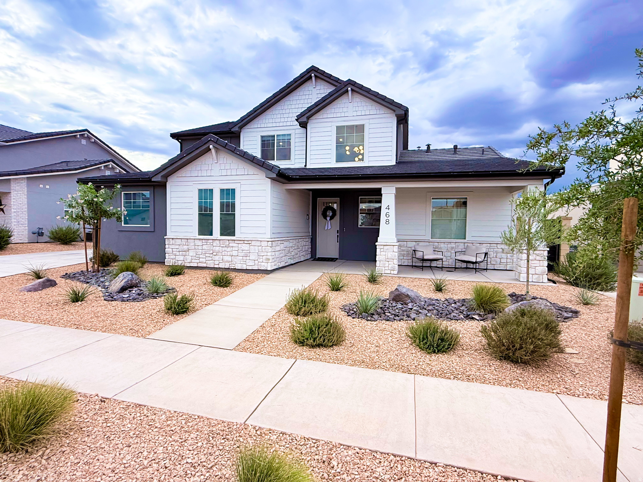 Perfectly located in the highly desirable community of Desert Color, this beautiful home offers the perfect blend of solid builder quality and thoughtful owner enhancements-complete with stunning views of Southern Utah's red rocks. While neighboring Visionary Homes boast excellent construction with robust 2x6 exterior framing, this residence stands out thanks to premium builder selections and high-value upgrades completed after construction. For a buyer, this means skipping the post-closing projects, delays, and out-of-pocket expenses to enjoy a completely finished, turnkey home from day one. The open-concept layout is designed for seamless living and effortless entertaining. In the kitchen, custom white oak cabinetry runs to the ceiling, complemented by soft-close hardware, pull-out shelving, a smart fridge, a farmhouse sink, and a commercial-grade 30" Forno gas range. An extra-large upgraded sliding glass door connects the kitchen to the extended concrete covered patio, private synthetic turf yard, and xeriscaping. Indoors, the home is elevated by eight-foot doors, modern black hardware, entry chandeliers, a cozy living room fireplace, and hidden in-wall TV wiring. The thoughtful split floor plan includes a primary suite oasis featuring a brass shower system with three shower heads (including a waterfall head) and a private stackable washer and dryer tucked into a master bath closet. Upstairs, a versatile loft selection offers the perfect second hangout space, playroom, or media lounge, located right alongside a spacious second laundry room with dedicated space to add a utility sink. Car and hobby enthusiasts will appreciate the extra-deep, fully insulated three-car garage, complete with durable epoxy flooring, custom storage, a highly convenient utility sink, and a 220V electric vehicle charging station. As a resident of Desert Color, your lifestyle is further elevated by incredible local growth and top-tier community perks. Lightning-fast fiber optic internet is fully included, and you are positioned just moments from all the exciting new shopping, dining, and entertainment coming to the immediate area-including the brand-new Costco right on Desert Color Parkway and the highly anticipated In-N-Out Burger. Located just one block from a local park and pool, you also have premier access to Desert Color's signature 2.5-acre white-sand lagoon, resort pool, and cabanas, delivering the ultimate Southern Utah lifestyle.