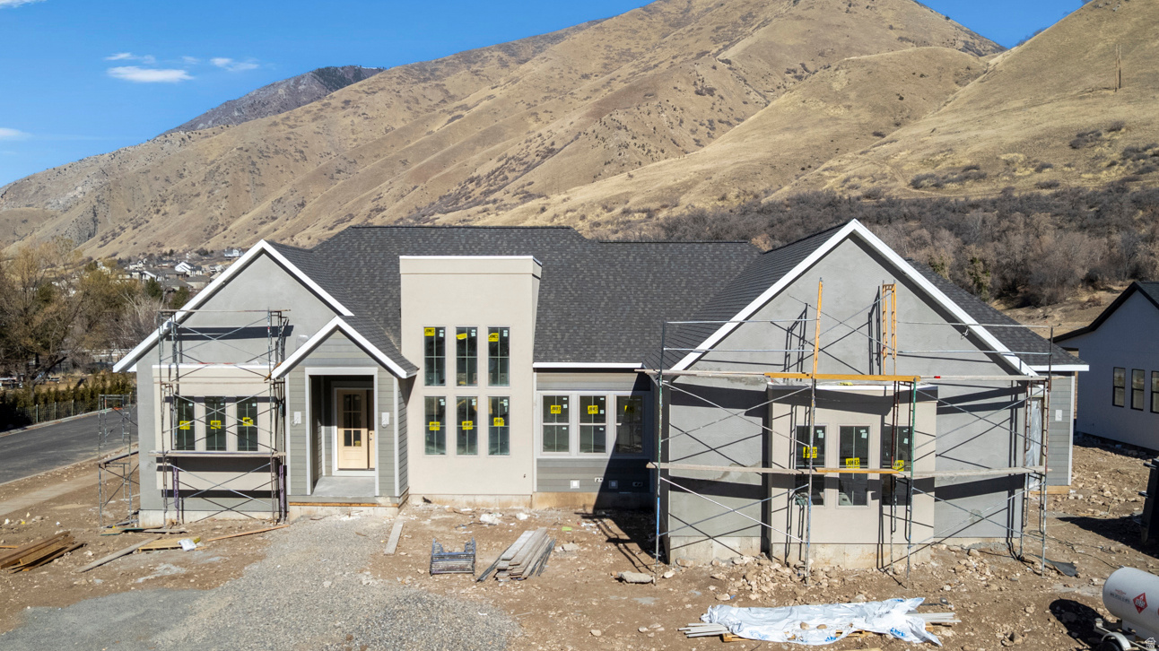 At the mouth of Hobble Creek Canyon, this brand-new custom home by Torchlight Homes - set for completion in April 2026 - offers a living experience rooted in beauty, calm, and craftsmanship. From the moment you step inside, the main level unfolds in a series of inviting, light-filled spaces, including a stunning great room, a gourmet kitchen with walk-in scullery, and a serene primary suite designed for true retreat. Covered patios create a seamless connection to the outdoors, extending everyday living into the natural landscape around you. The lower level adds remarkable flexibility with 10' ceilings, its own private entrance from the garage, a full kitchen, generous laundry, and a large theatre room. Whether for extended family, long-term guests, or simply additional space to live and gather, it offers possibilities that elevate comfort and connection. Set on a generous 0.44-acre lot in one of Springville's most special locations, this home pairs thoughtful design with an irreplaceable setting - where canyon trails, open space, and quiet evenings become part of daily life. A rare opportunity to claim a luxurious new build in a place that truly feels like home.