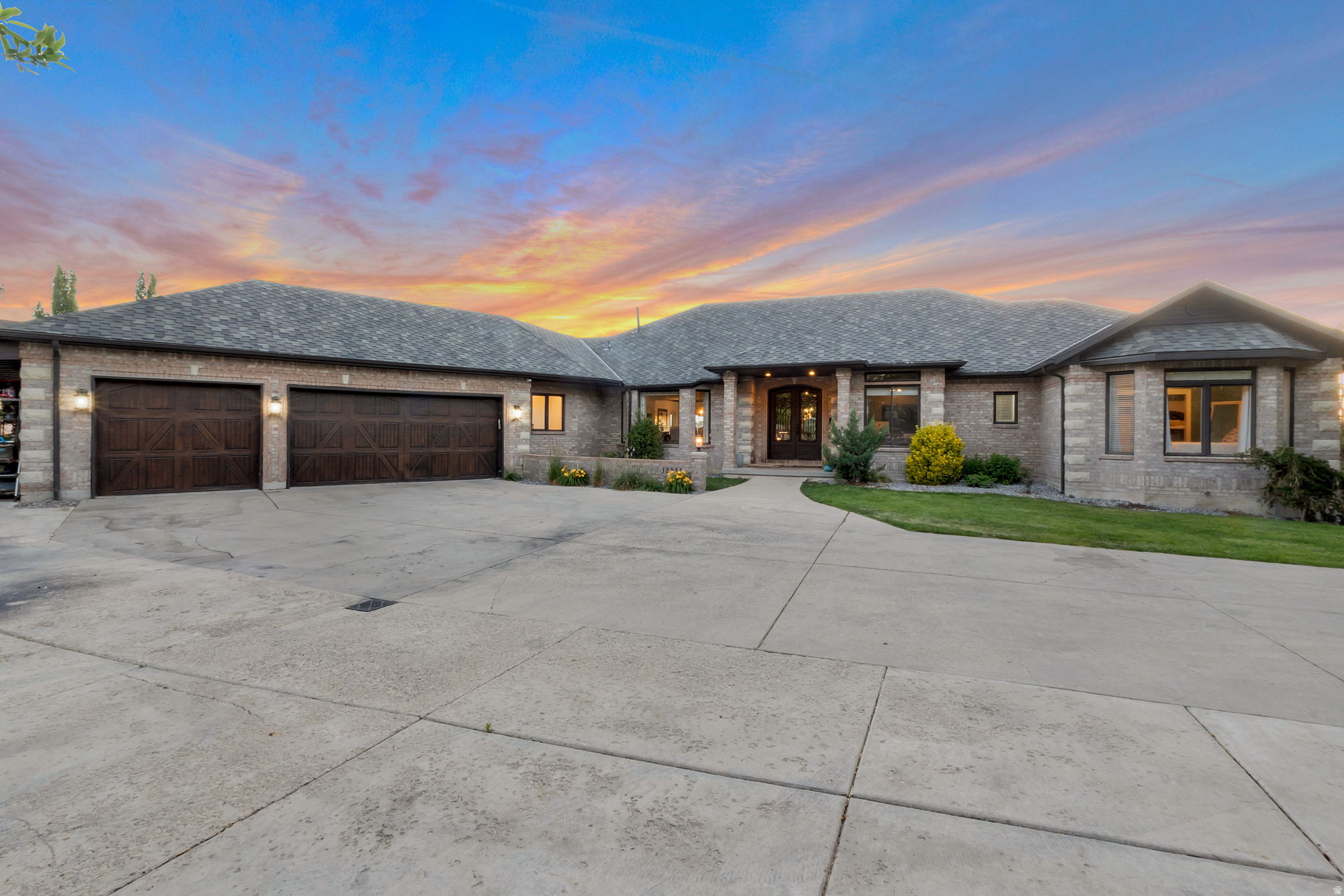 Rarely does a property of this caliber come to market in Draper. Set on a full acre of private, fully fenced grounds with an electronic gated entry, this 7,760-square-foot estate delivers a level of land, luxury, and lifestyle that simply cannot be replicated on the half-acre lots that dominate the area. This is not a subdivision home with a neighbor's stucco wall six feet from your bedroom window. This is a genuine estate - with space to breathe, space to gather, and space that few properties in Salt Lake County can offer. Step inside and the finishes speak immediately. Brazilian hardwood flooring runs throughout the main level - not engineered, not laminate, but solid exotic hardwood sourced for both beauty and durability. Custom ironwood doors anchor the entry and main living spaces, setting a tone of craftsmanship that continues through every room. The kitchen is outfitted with a full GE Monogram appliance suite, including a double oven with microwave/oven combination, designed for serious cooking and effortless entertaining. Six bedrooms and seven bathrooms provide generous accommodation, while the dedicated home gym, theater room, and basement access directly from the garage add layers of functionality that reveal themselves the longer you stay. The primary suite is a retreat in the truest sense - spacious, private, and bathed in natural light - with a spa-inspired ensuite featuring dual vanities, a deep soaking tub, and an oversized walk-in shower. Every bedroom is proportioned for comfort, not squeezed in to hit a room count. The floor plan balances open-concept living with defined spaces, so you get the grand entrance and the great-room drama without sacrificing the quiet corners that make a house a home. But the grounds are where this property separates itself from every other listing in Draper. The centerpiece is a resort-caliber 40-by-26-foot gunite saltwater pool - not a vinyl-lined afterthought, but a professionally engineered installation with a covered spa integrated within the pool perimeter and a natural rock wall feature designed for jumping and diving into the deep end. Surrounding the pool, a 1,000-square-foot wraparound deck crafted from Ipe Brazilian hardwood provides elevated outdoor living with panoramic sunset views over the Wasatch Front. A mature fruit orchard, fully irrigated, delivers not just beauty but harvest - peaches, apples, cherries, depending on the season. The entire outdoor space is served by a poolside bathroom, so wet feet never cross the threshold. Additional features include a three-car attached garage plus a separate carport, a heated garage with epoxy flooring, a full-home water filtration system, and a brand-new roof installed November 2024 with a fully transferable 25-year warranty. The home was comprehensively remodeled in 20172018, meaning systems, finishes, and fixtures are modern and move-in ready - not a time capsule waiting for the next owner's renovation budget. This is a property for the buyer who understands the difference between square footage and land, between a pool and a resort, between a house and an estate. Private showings by appointment. Pre-qualification or proof of funds required.