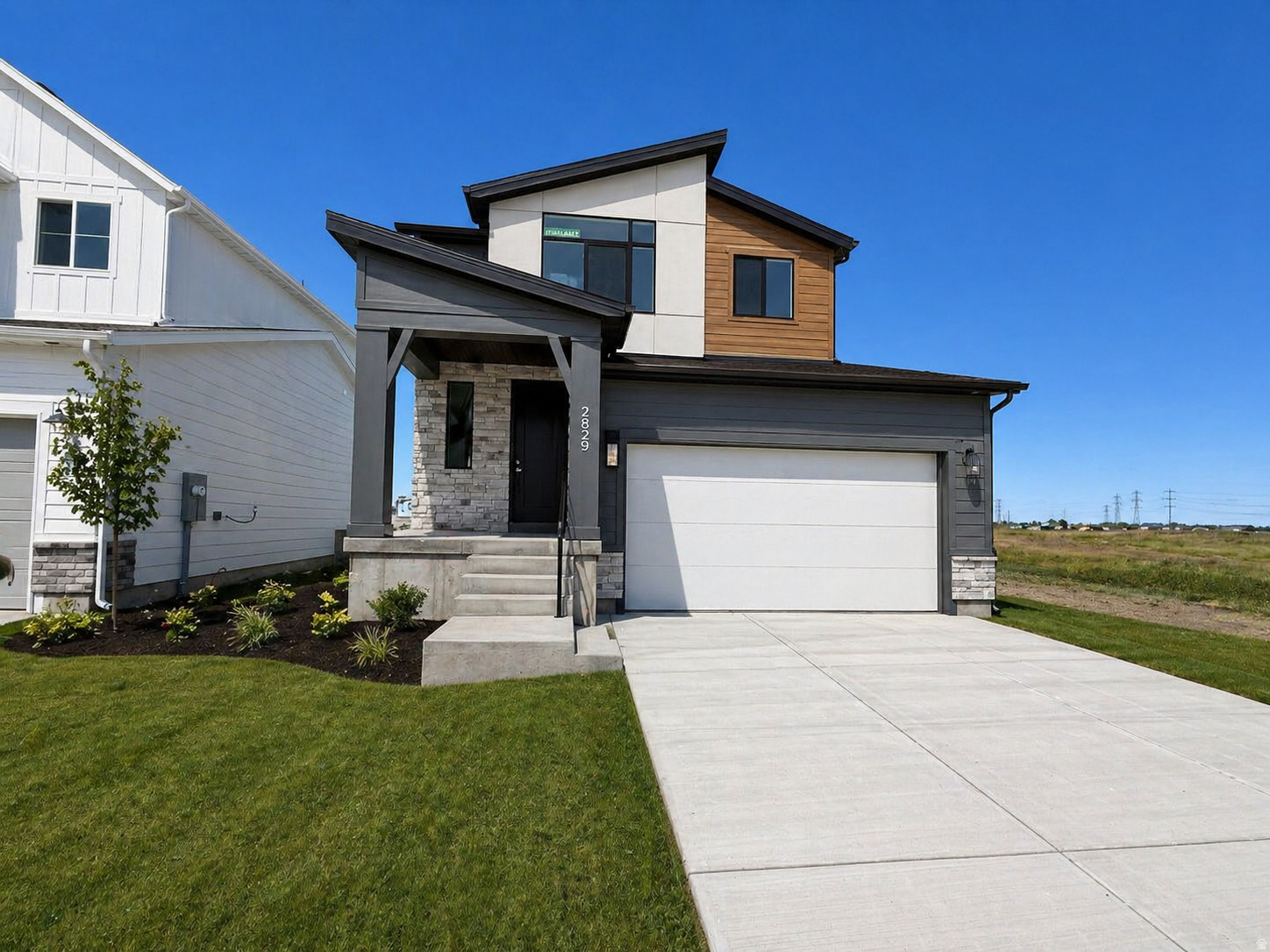 Welcome to this beautifully designed, Move-In Ready, new construction home featuring a modern exterior and a thoughtfully designed layout. This home offers the perfect blend of style and functionality with quality finishes throughout.  The open-concept main level includes a bright and spacious great room, a large kitchen with a central island, and a dining nook with abundant natural light from oversized windows. Upstairs, enjoy a private primary suite with a well appointed bathroom, along with additional bedrooms and a conveniently located laundry room.  The finished basement adds valuable living space, perfect for a recreation room, guests, or entertaining, and includes a dedicated cold storage room for extra storage.  Additional highlights include a 2-car garage, covered front porch, and modern design elements throughout. Plus, this home backs to a future park within the community, offering added privacy and a great outdoor setting right out your backyard. *Main image has been digitally landscaped to show potential.*