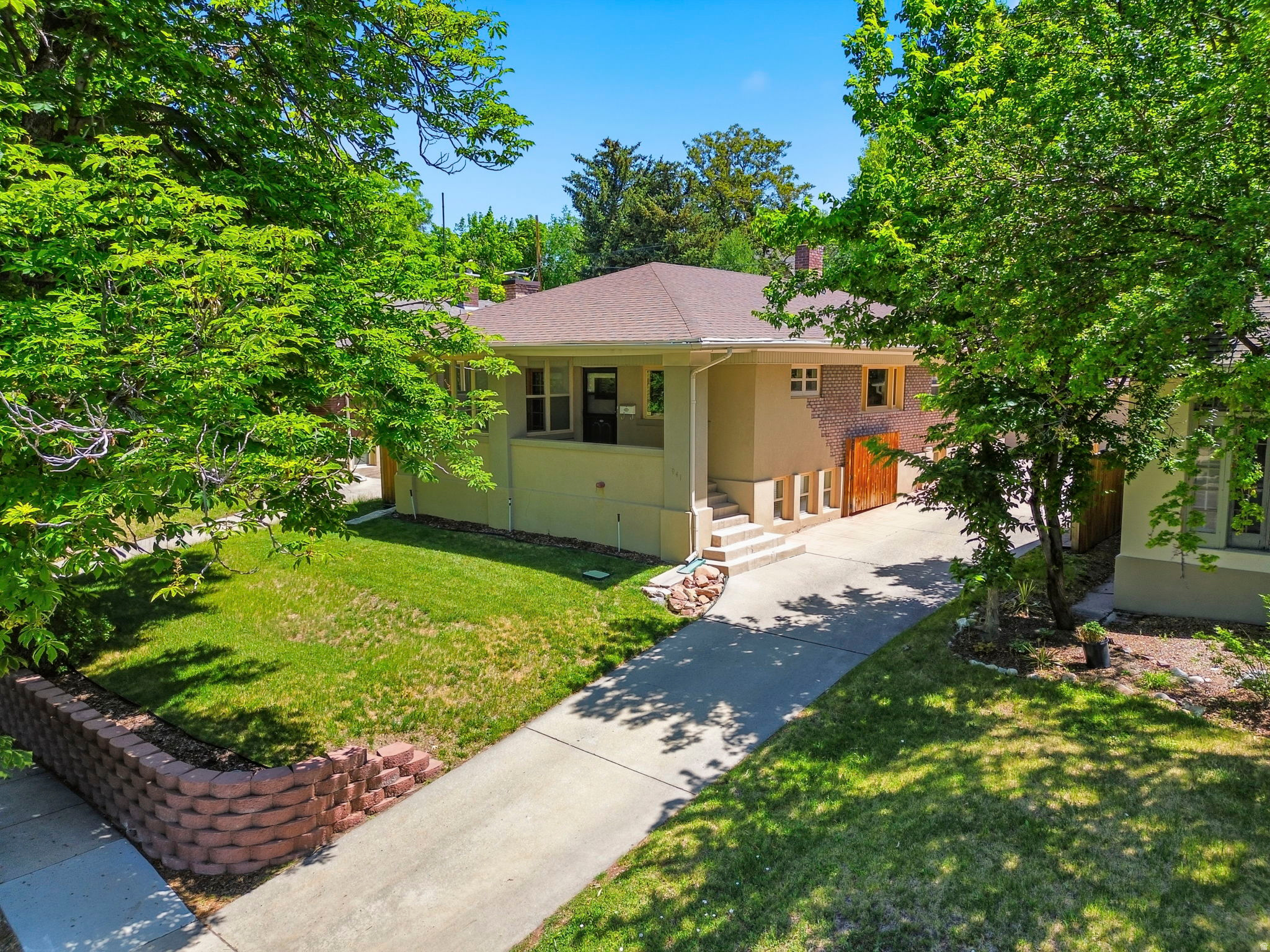 Classic charm meets unbeatable location in this beautifully maintained home nestled among mature trees in one of Salt Lake City's most desirable and walkable neighborhoods. Just minutes from the 9th & 9th district, the University of Utah, local parks, restaurants, coffee shops, and shopping, this home offers the perfect blend of character, convenience, and lifestyle.  Inside, you'll find an abundance of natural light, gorgeous hardwood floors, and rich original wood trim that showcase the home's timeless craftsmanship. The spacious living room features a cozy fireplace, built-in cabinetry, and large windows that create a warm and inviting atmosphere. Thoughtful architectural details throughout add to the home's unique character and appeal. The kitchen and dining areas provide comfortable everyday living, while the functional floor plan offers flexibility for a variety of lifestyles.  Surrounded by mature trees and established landscaping, the fully fenced backyard offers exceptional privacy. Located within a highly regarded school district and just moments from some of Salt Lake City's most vibrant destinations, this home presents a rare opportunity to enjoy classic character in an exceptional location.