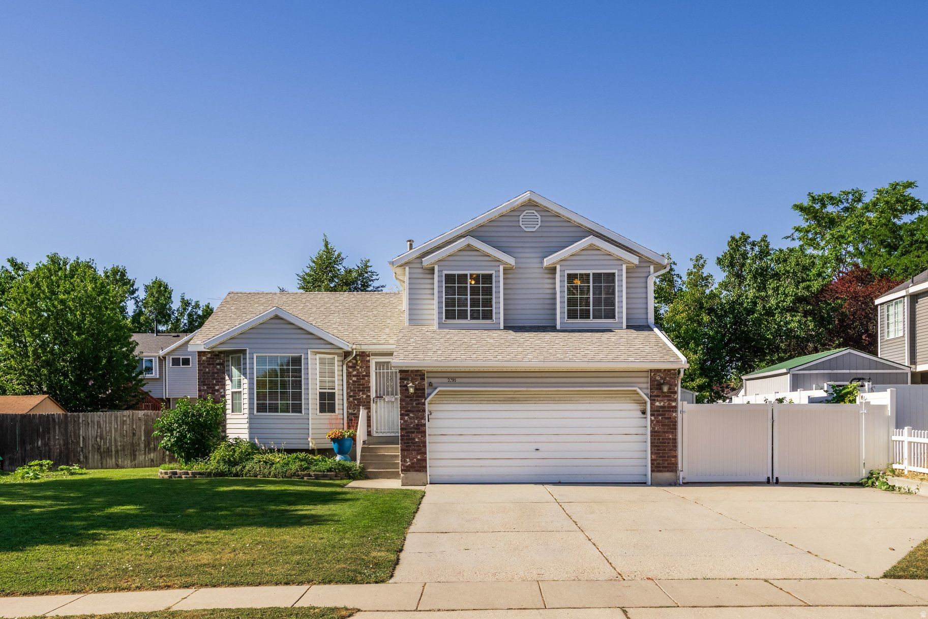 This well-maintained split-level home offers approximately 2,000 square feet with four bedrooms and multiple living spaces. The main level features a bright living room with a large bay window, along with an updated kitchen and dining area with granite countertops, generous workspace, and abundant natural light. A separate family room includes a fireplace and sliding doors that open to the covered backyard patio. LVP flooring extends through most of the home, and the flexible layout provides space for gathering, working from home, or accommodating guests. The fully fenced yard is spacious and includes large garden areas and numerous raised beds, a large chicken coop, mature trees, storage sheds, and gated side access with additional concrete parking. An attached two-car garage, RV pad on the side of the home and convenient location make this home a great opportunity!