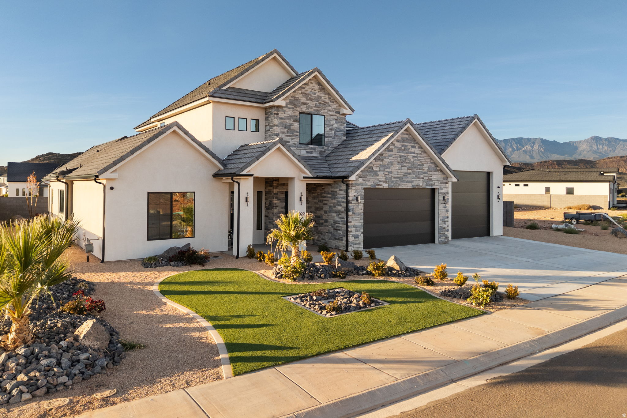 Welcome to 2022 S Blossom Way, where modern comfort meets Southern Utah charm and sunshine. This Stunning new build from Novelty Homes is located in the desirable Oak Haven Community. It features an open, functional 5 bedroom 3 and a quarter bath floor plan, filled with natural light and spacious cabinet/storage space for everyday living. The home has a large kitchen area with top of the line features, including a 60 inch fridge/freezer, and an upgraded cooktop/oven. The entire home has pristine upscale high-end finishes. The home was designed with a $20,000 thoughtful designed-distributed audio/sound system throughout the home. Sound system is a 4 zone audio system with a 5 speaker surround sound set up in both the great room and upstairs family room for enjoyable entertainment. Home comes with a full cat6 network system making all network jacks in the house live, with 2 access point network boosters for WiFi. The home is equipped with a 9 camera surveillance system with the doorbell included in that.  Property highlights a full 4 car garage with extra height and depth. Home is beautifully landscaped and move in ready! Close to some of the most amazing Southern Utah golf courses and outdoor recreation areas.