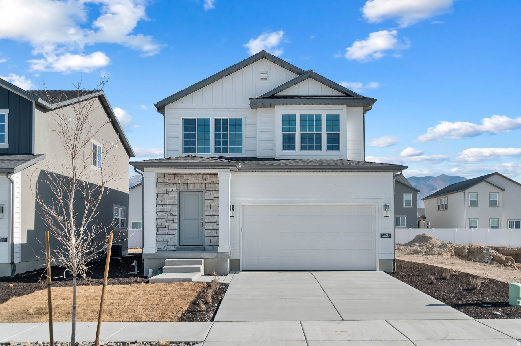 This contemporary Carson home features a sleek interior with refined finishes throughout. The kitchen is equipped with Shale Maple cabinetry, quartz countertops, and stainless steel gas appliances, creating a warm yet modern space ideal for everyday living and entertaining. Laminate hardwood flooring highlights the main living areas, complemented by vinyl tile and carpet for durability and comfort. Can lighting and craftsman base and casing add a polished, cohesive design. Additional features include a tankless water heater, convenient Christmas light outlets, and energy-efficient options. The owner's bathroom is finished with cultured marble shower surrounds and satin nickel hardware, offering a clean, low-maintenance finish. A thoughtfully designed home blending modern style, comfort, and efficiency.