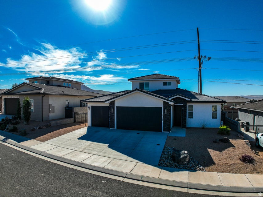 Beautifully upgraded and move-in ready inside and out! Functional floor plan with the primary suite on the main level - complete with its own laundry area and a walk-in/roll-in shower. Two additional bedrooms are located upstairs near the main laundry. Upgraded finishes throughout, including plantation shutters, custom soft-close cabinetry, and no-step access to the main level from every entrance. Fully landscaped backyard with a spacious covered patio - perfect for relaxing or entertaining. All appliances stay, including both sets of washers and dryers. Three-car garage with epoxy-coated floors and extra storage, plus bonus under-stair storage in the primary closet. Everything looks and feels brand new!
