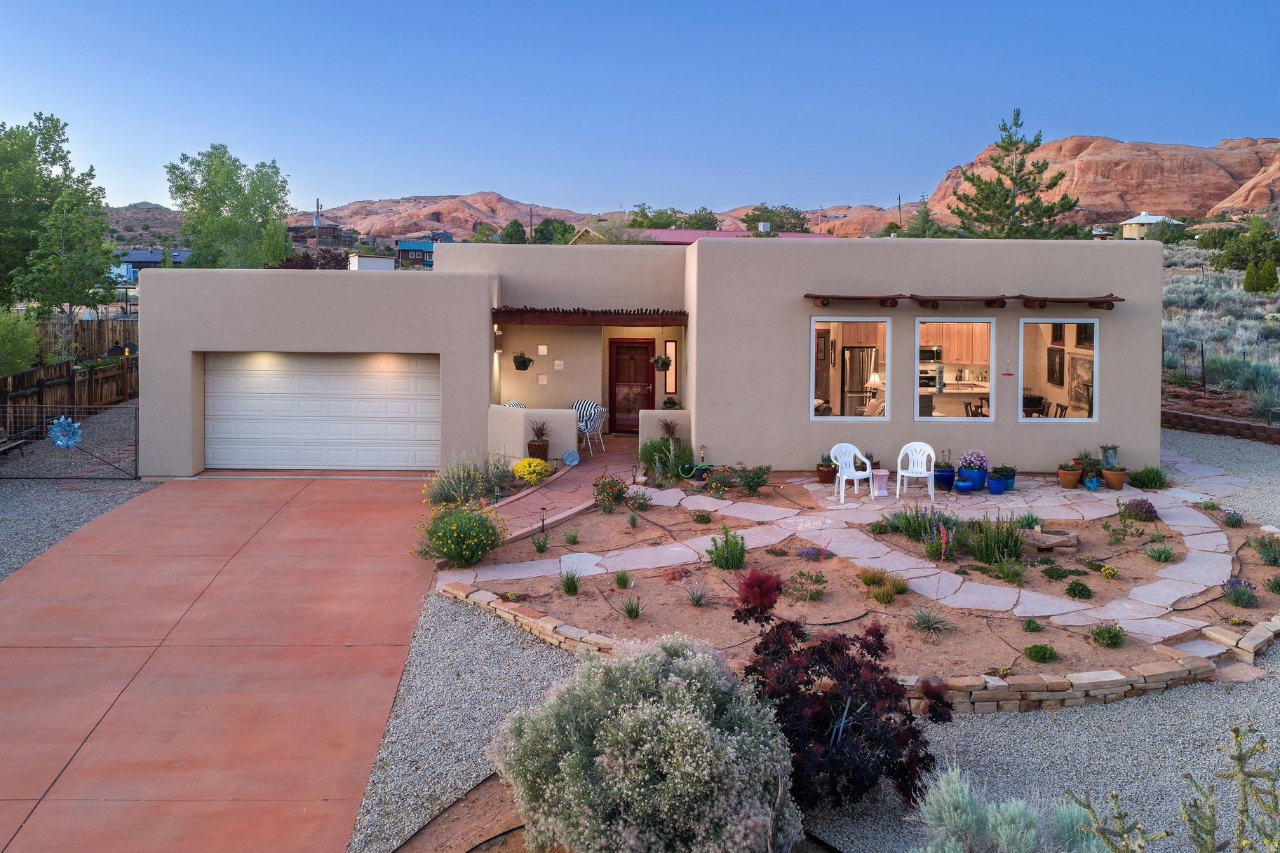 Red Rock Views & Outdoor Living | .36 Acre near Moab's beautiful golf course, this 3-bedroom, 2-bath home showcases exceptional attention to detail and the best of Moab living. The open floor plan features abundant natural light from expansive windows, along with power blinds in the living room for comfort and convenience. Sliding glass doors in the primary bedroom and one additional bedroom, along with a hallway door to the backyard, provide seamless indoor-outdoor access.  Step outside to an uncovered patio with a hot tub, perfect for relaxing under Moab's star-filled skies. The backyard also includes a pergola, all set on a spacious lot designed for enjoying the surrounding landscape. Low-maintenance landscaping gives you plenty of time to take advantage of all that Moab has to offer. Located only a half mile from Steel Bender access, this property is ideal for outdoor enthusiasts.  Square footage figures are provided as a courtesy estimate only and were obtained from county records. Buyer is advised to obtain an independent measurement.