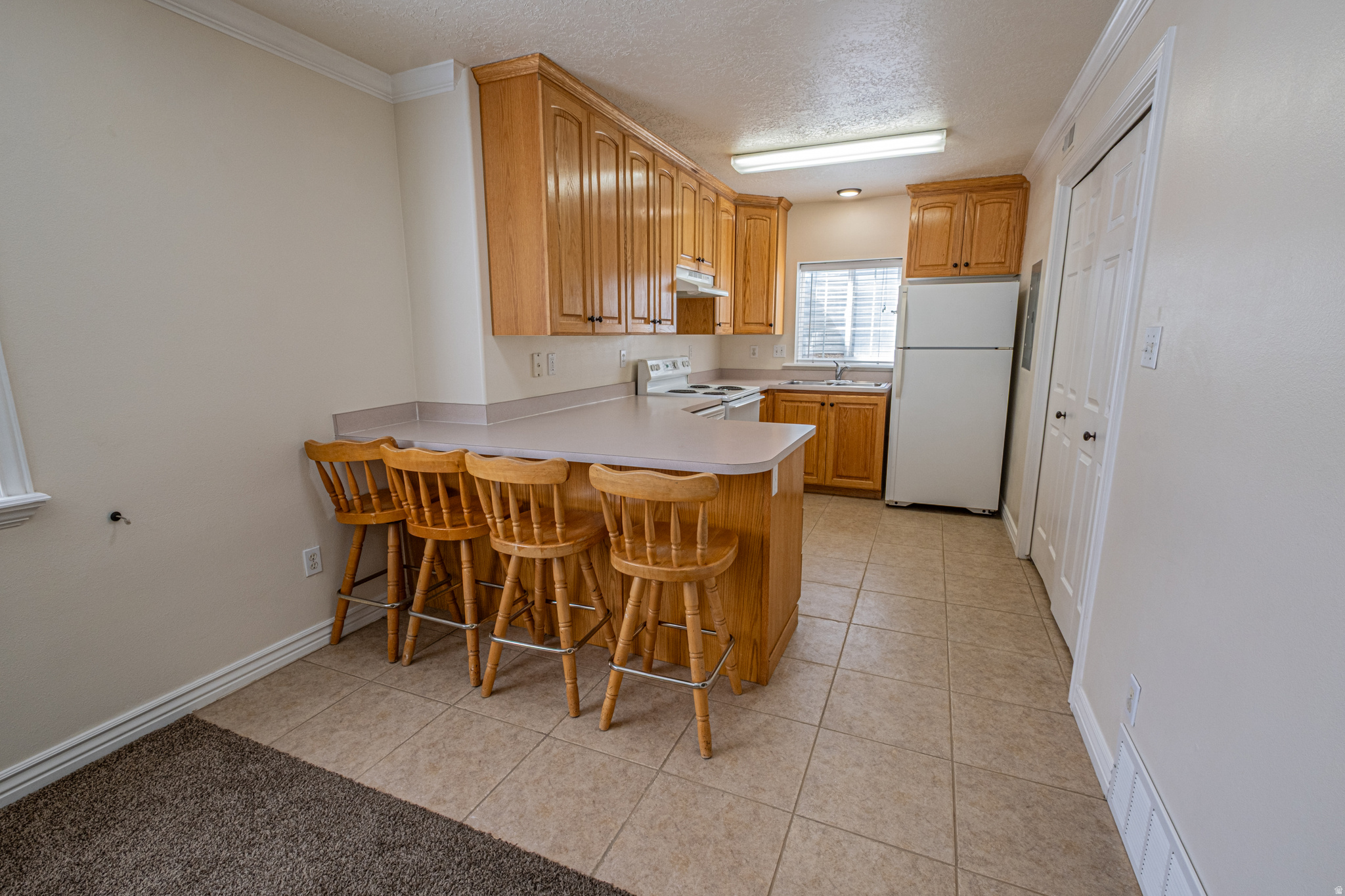 One of the best-priced condos in Utah County and in a great little community. Located a short distance from shopping, schools, and I-15. Plenty of parking within the community, with 2 assigned parking spots (One covered and one uncovered). The quiet HOA has a spacious pavilion/picnic area and playground as well as grass space. The owners have put great care into maintaining this condo. Easy to Show. Barstools are included. Buyer and Buyer's Agent to verify all information.