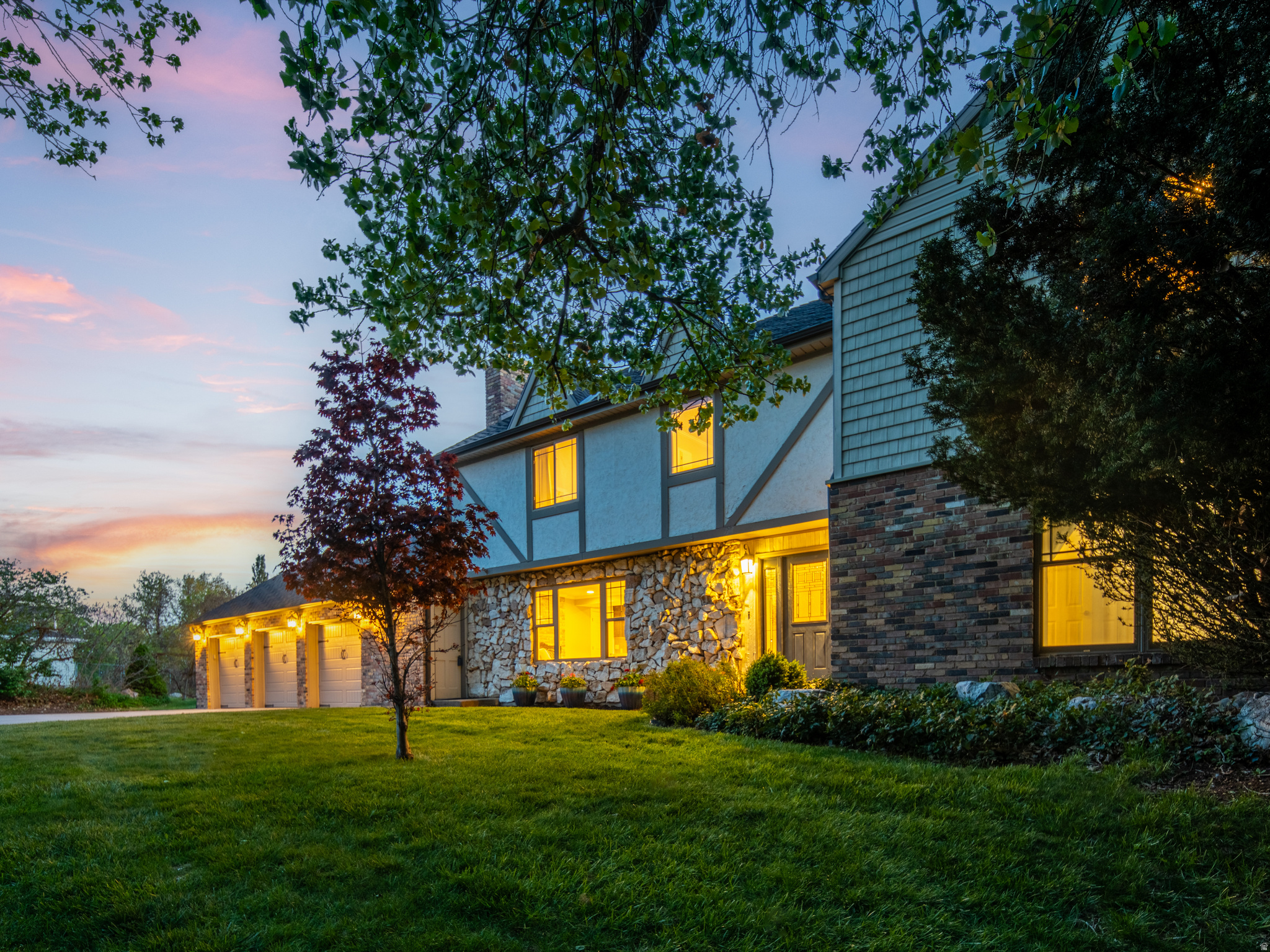 Privacy and mountain views on nearly an acre, minutes from the city - this Tudor-style estate is tucked against the Wasatch foothills, surrounded by mature oaks and pines. The ridgeline rises dramatically just beyond the home, creating a setting that feels both secluded and connected to nature. Two expansive 50-foot decks and a lower patio extend the living space outdoors, where a private waterfall feature and mountain backdrop create a retreat for entertaining or quiet evenings at home.  Inside, the home has undergone a comprehensive professional renovation, blending timeless Tudor character with updated design and infrastructure - designer-selected finishes, new hardwood flooring, a fully remodeled chef's kitchen, and extensive mechanical and electrical updates throughout. The primary suite opens directly to the upper deck, while the lower level includes a fully independent guest or in-law suite with its own entrance and kitchen, offering flexibility for extended family, guests, or multi-generational living.  Featuring six bedrooms, 4,526 square feet, and two parcels, this is a property that combines space, privacy, and mountain living in one of the valley's most distinctive settings. All property information, boundaries and documents to be verified by buyer.