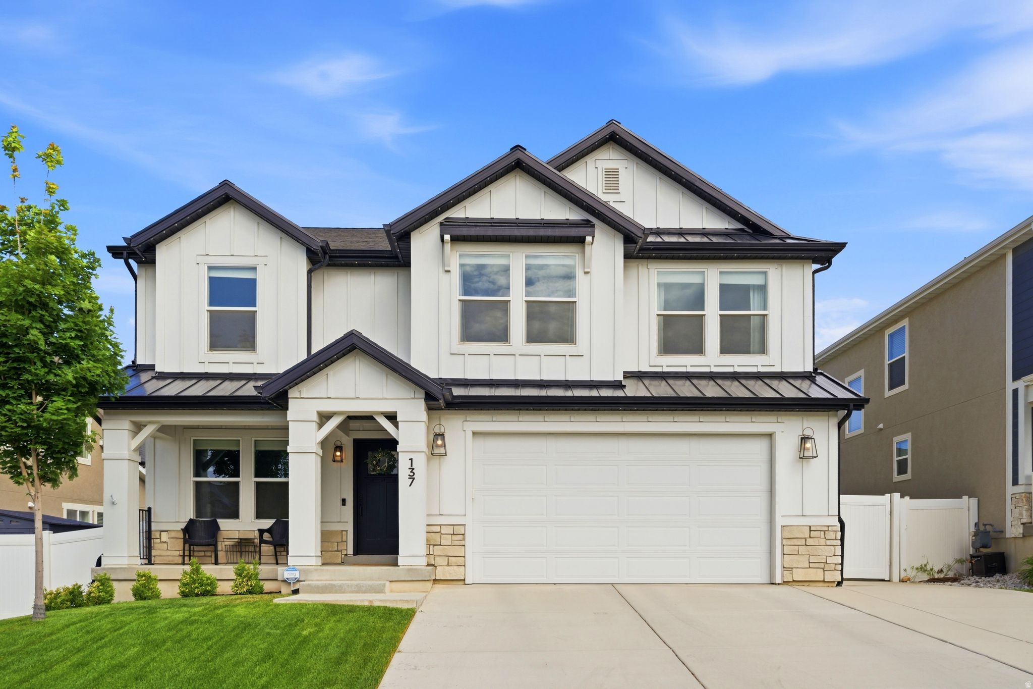 Beautifully upgraded home with stunning mountain views and exceptional curb appeal featuring white Hardie board exterior and a spacious front porch perfect for relaxing and enjoying the neighborhood. Inside, you'll find open-concept living with designer finishes throughout, a large kitchen with double ovens, oversized island, custom built-in shelving, and thoughtfully selected upgrades at every turn. The functional floor plan offers four bedrooms upstairs, including a spacious primary suite with a large shower and luxurious feel. Step outside to enjoy the private backyard complete with a large deck and hot tub-perfect for entertaining or unwinding. The unfinished basement is already highly functional with finished-style wall coverings and rubber mat flooring, creating flexible space for a gym, playroom, storage, or future expansion. One of the most upgraded and visually impressive homes in the neighborhood, offering style, function, and incredible mountain views.