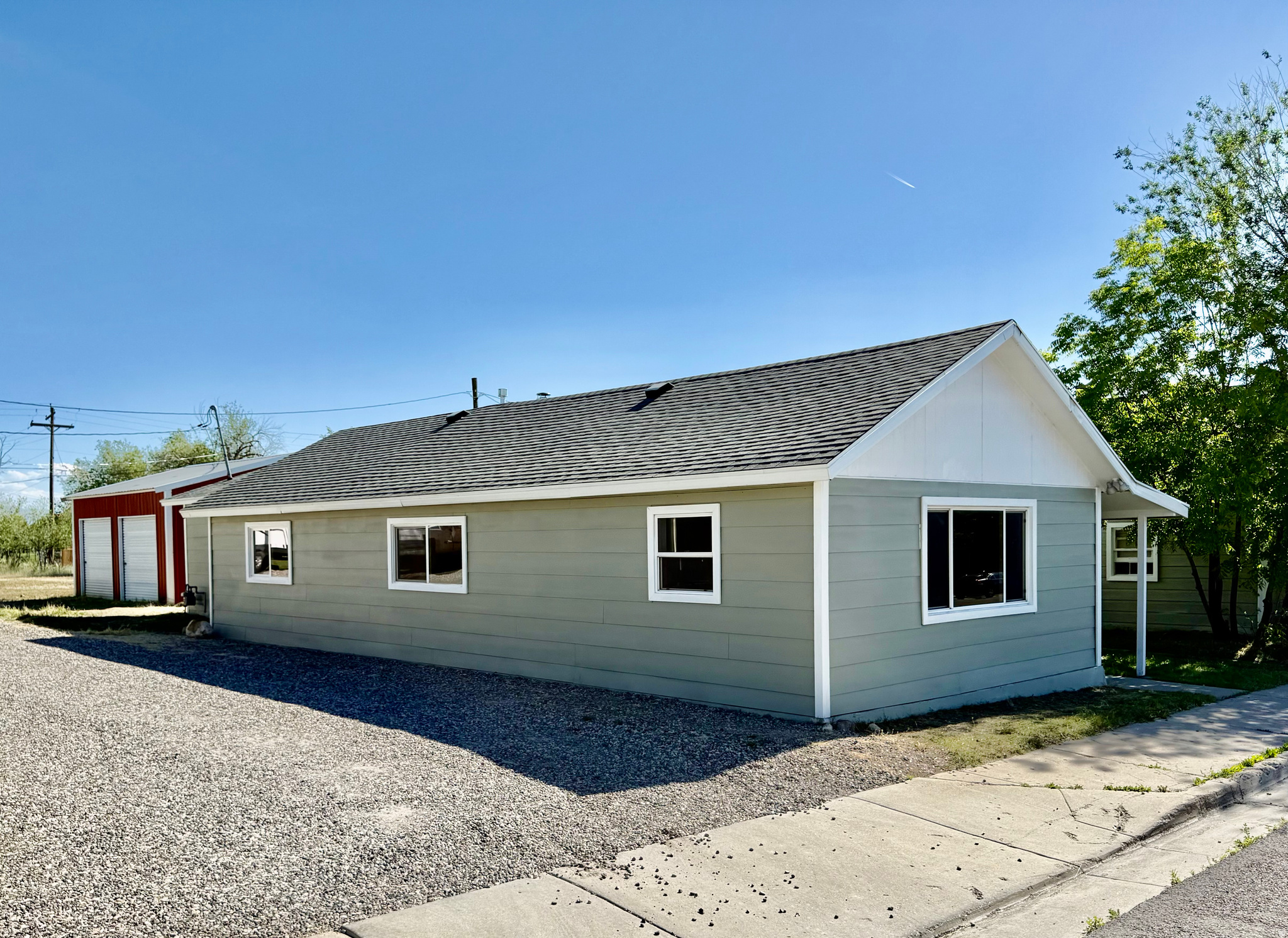 Located in the heart of a peaceful small town, this beautifully remodeled 4-bedroom, 2-bathroom home offers over 2,000 square feet of updated living space. Situated on a third-acre lot, this property combines the comfort of a spacious interior with the charm of a rural setting. Inside, you'll find a bright and welcoming atmosphere with an open layout designed for everyday living. The spacious living room centers around a cozy wood-burning fireplace, creating the perfect gathering space. The kitchen features modern granite countertops, a double oven, and ample cabinet storage. Both bathrooms have been thoughtfully updated with stylish modern finishes, offering comfort and convenience. Outside, the deep lot provides a generous backyard with plenty of room to relax, entertain, or enjoy outdoor activities. A standout feature of the property is the detached shop, offering abundant space for projects, hobbies, equipment, or additional storage. Located in a friendly, close-knit community, this home presents a wonderful opportunity to enjoy the benefits of small-town living while remaining conveniently close to local amenities.  Square footage figures are provided as a courtesy estimate only and were obtained from county.  Buyer is advised to obtain an independent measurement. Buyer and buyers agent/broker to verify all information.