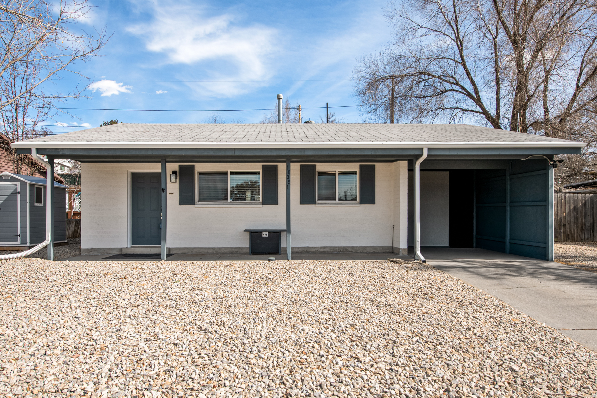 Fully remodeled, move-in ready single-level home located in a quiet neighborhood. Major updates include new plumbing & electrical. Spacious yard with direct trail access behind the property - perfect for walking, biking, or enjoying the outdoors. Low-maintenance xeriscaped landscaping, covered carport, and two storage sheds provide great functionality & storage. Extra side-yard parking with room for an RV, trailer, or recreational vehicles. Granite countertops, SS appliances, water softener, walk-in closet, mud room, EV charger. A great opportunity for comfortable, low-maintenance living.
