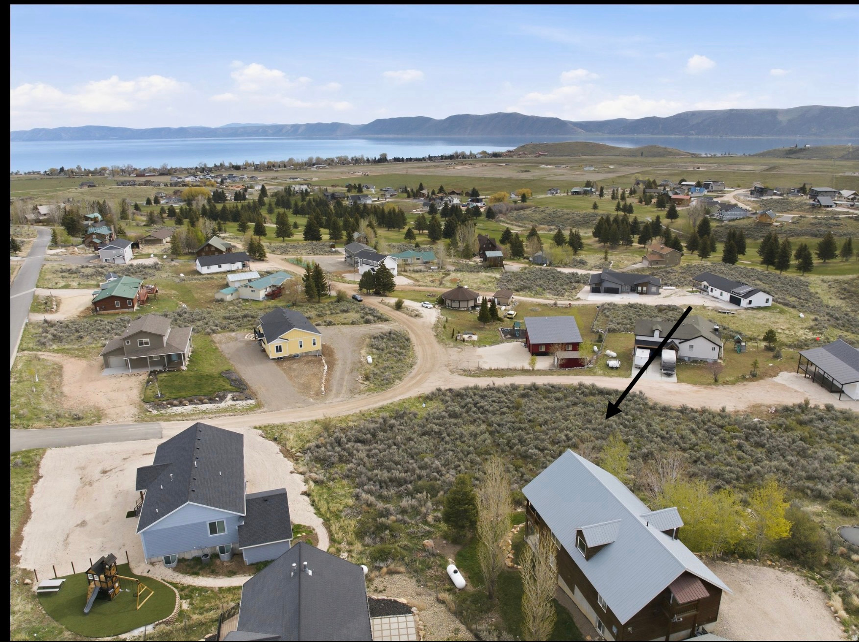 Build your dream home in the desirable Sweetwater Golfcourse community.  This beautiful building lot offers stunning views of Bear Lake and is conveniently located near the Bear Lake Golf Course. Paved roads will be in this area soon. Ideal Beach amenities are available to buy into each year.  They include a private sandy beach, swimming pool, tennis/pickleball, put-put golf and more.