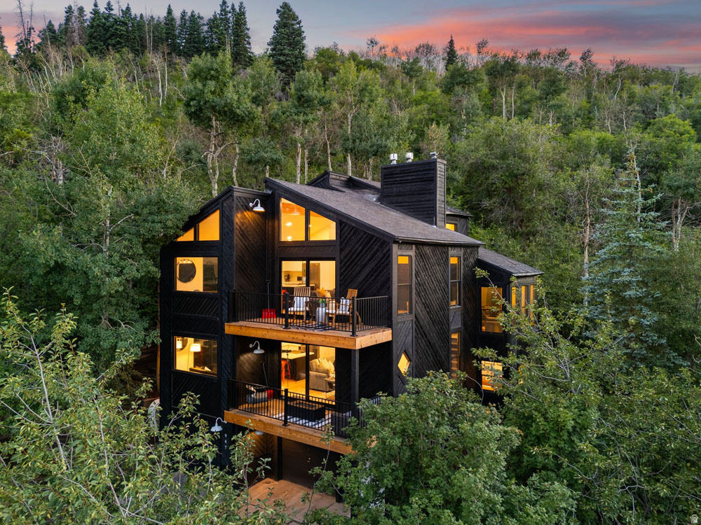 Rare Duplex-Style Residence on 1.03 Acres in Old Town with views!   One-of-a-kind property in Old Town Park City, this exceptional 1.03-acre Treasure Hill offering blends privacy, flexibility, and mountain-modern living. Remodeled in 2023, the 3,108 SF residence features clean architectural lines, two fully renovated kitchens, updated bathrooms, new flooring and carpet, and a striking cedar herringbone exterior. Originally built in 1976 and free from historic site restrictions, the home is surrounded by the iconic Sweeney Switchbacks, Creole Ski Run, and Park City Mountain Resort, with sweeping hillside and Old Town views.  Designed with a true duplex-style layout, the home includes two complete and independent living spaces, each offering two bedrooms, two bathrooms, and a full kitchen. This configuration provides exceptional versatility-ideal for nightly rentals, multi-generational living, hosting guests, or owners seeking a lock-off-style investment while maintaining privacy.  Enjoy panoramic views of Old Town with Deer Valley as a dramatic backdrop and unforgettable sunsets from this elevated mountain perch. The location is unmatched: just a five-minute walk to Historic Main Street and Park City Mountain Resort, a short drive to Deer Valley, and immediate access to hiking trails and ski routes.  Offered fully furnished and move-in ready, the home is turn-key for personal use or rental income. The expansive lot also offers future development potential, allowing for a single-family residence or duplex. Just 25 minutes from Salt Lake City International Airport and minutes from Park City's world-class amenities, this is a rare opportunity on one of Old Town's most prestigious hillsides.