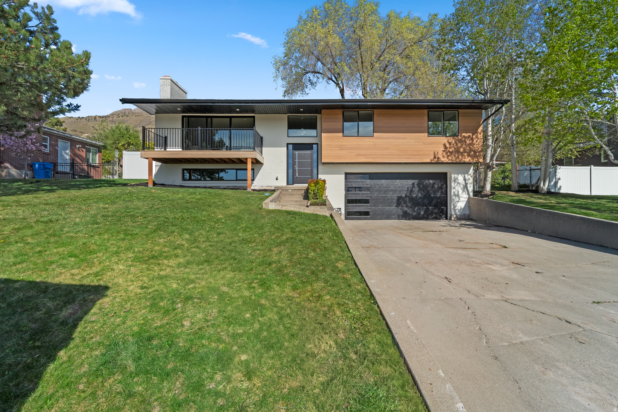 Beautifully maintained 2,237 sq. ft. home featuring 4 bedrooms and 2.5 bathrooms, with fresh paint and brand-new carpet throughout. Enjoy stunning valley, mountain, sunset, and city light views from the balcony off the spacious living area with a cozy fireplace.  The kitchen overlooks a fully fenced, flat backyard with a sprinkler system. The main level offers three bedrooms, including a primary suite, while the finished basement includes a second living area with a fireplace, a fourth bedroom, and ample storage.  Complete with a two-car garage and conveniently located near schools, parks, shopping, and I-80, just 3540 minutes from Park City. A perfect blend of comfort, location, and value.