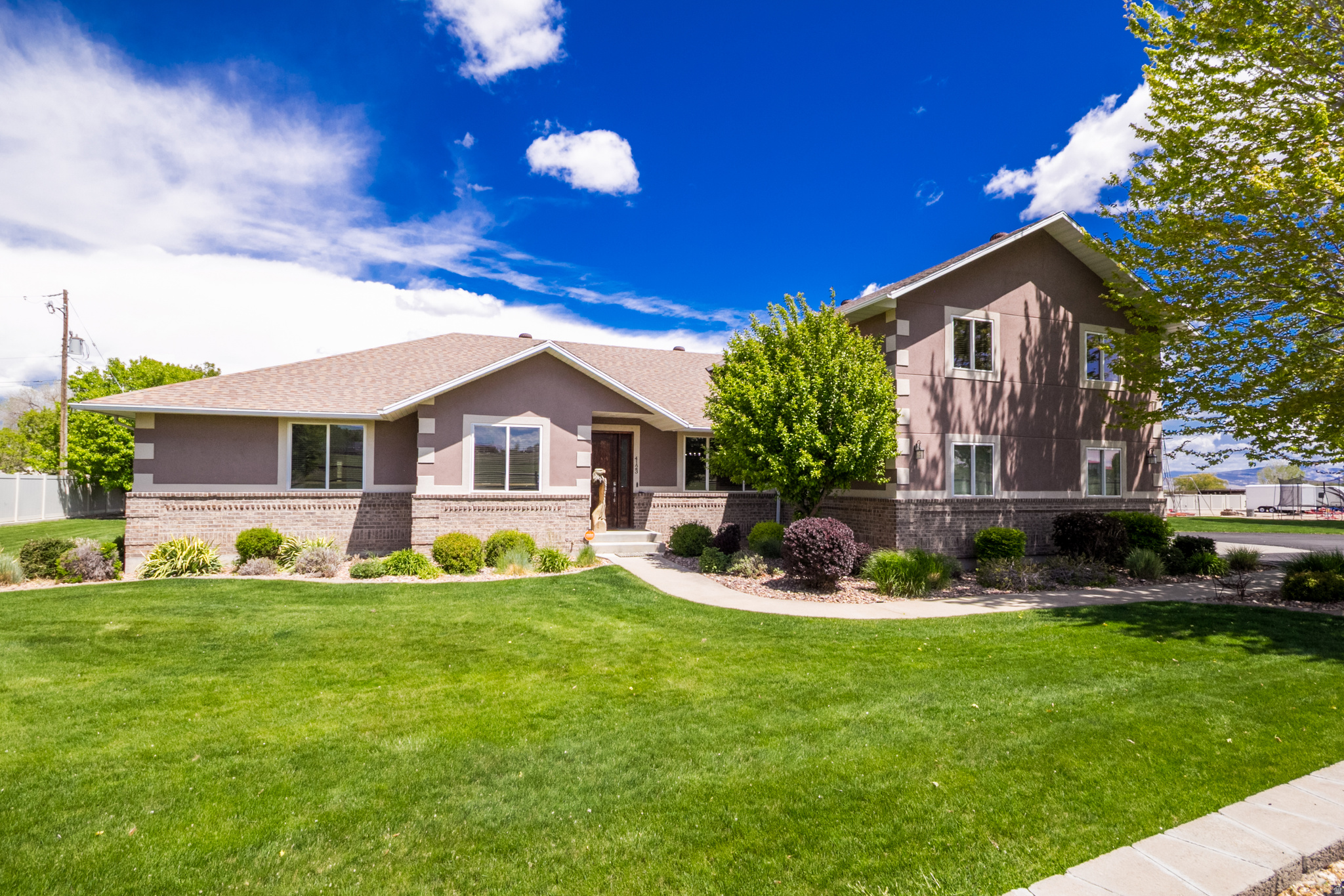 Absolutely stunning 4 bedroom, 2.5 bathroom home on 1.95 acres with views that will stop you in your tracks. This property truly has it all. The home features a beautiful covered patio that feels like a dream, perfect for soaking in the quiet and the scenery. Inside you'll find a spacious layout plus a bonus room upstairs with its own bathroom, giving you flexible space for guests, hobbies, or a second living area. Outside is where this property really shines. Fully fenced with a private drive, mature trees, and incredible landscaping that has been thoughtfully done. There are fruit trees, a sand area for kids, and plenty of room to enjoy the outdoors. The 30x30 heated shop is a standout with a 12x14 garage door and an enclosed lean-to, making it ideal for projects, storage, or all your toys. Connected to city water and includes one share of Ashley Valley Reservoir water. Peaceful, private, and truly one of a kind. This is the kind of property people wait for. Prequalified buyers only please. Buyer to verify all information.