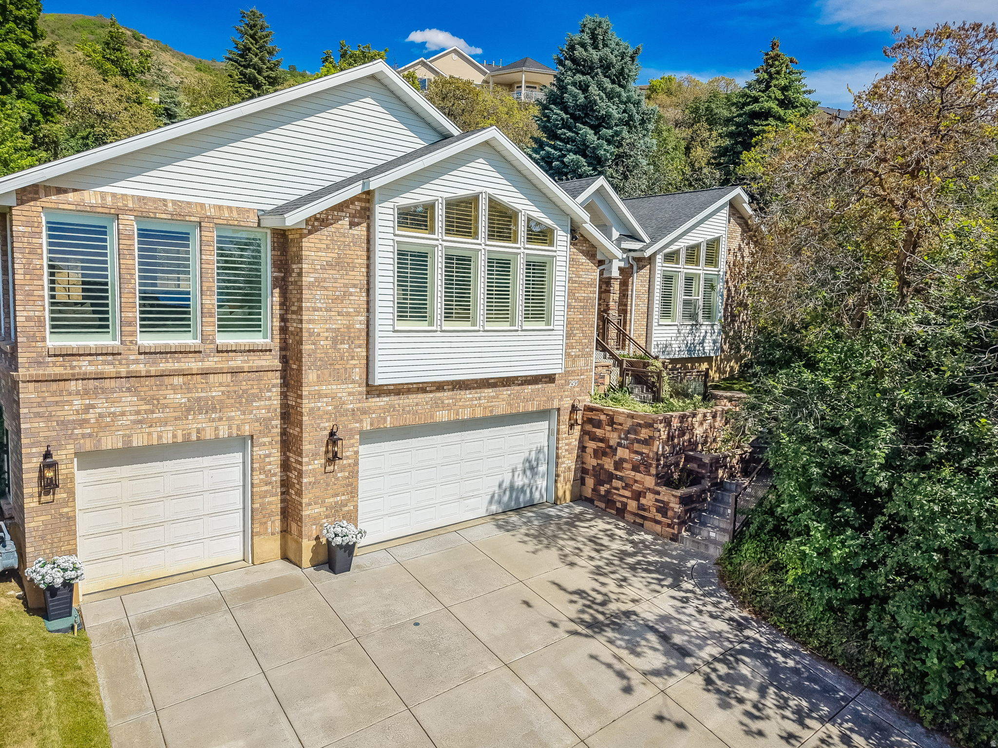 Fully renovated and move-in ready, this Bountiful stunner sits on over half an acre at the end of a quiet cul-de-sac - offering luxury finishes, designer details, and incredible views in one of Davis County's most sought-after neighborhoods. Tucked into an established community with a highly regarded school district, easy canyon access, and quick connections to Salt Lake, this home delivers lifestyle and location in equal measure. Step inside to 14-foot vaulted ceilings, designer chandeliers from Anthropologie and Neiman Marcus, and a chef's kitchen built to impress - featuring a massive 5' x 10.5' quartz island, 9-foot custom cabinetry with hidden paneled Bosch dishwasher and integrated pantry, Viking double ovens, a 48" 7-burner gas cooktop, Bosch refrigerator, and a hidden drawer microwave. Every cabinet includes custom rolling drawers. The great room invites you in with a custom stone gas fireplace, built-in bookshelves, and an 85" Samsung Frame TV (included). Retreat to the spa-like primary en-suite with a large shower and deep soaking tub. Downstairs, a fully renovated basement kitchen with granite countertops and full-size appliances is perfect for entertaining or multigenerational living. Premium extras: central vac, heated driveway and front steps, dual water heaters, dimmer switches, gold hardware, and new lighting throughout. Renovated 20232024: full kitchen remodel, all bathrooms, new flooring (LVP hardwood, carpet, wood stair treads), interior paint, electrical updates, and basement kitchen. Included: Washer/dryer and all appliances (new in 2023), Samsung Frame TV, family room furniture, patio dining set, sectional, swing, fire pit table, office desk, basketball standard, electric fireplace in primary suite, and shed. Basement sectional negotiable. Don't miss your chance to own this turnkey Bountiful gem with views, finishes, and location to match.