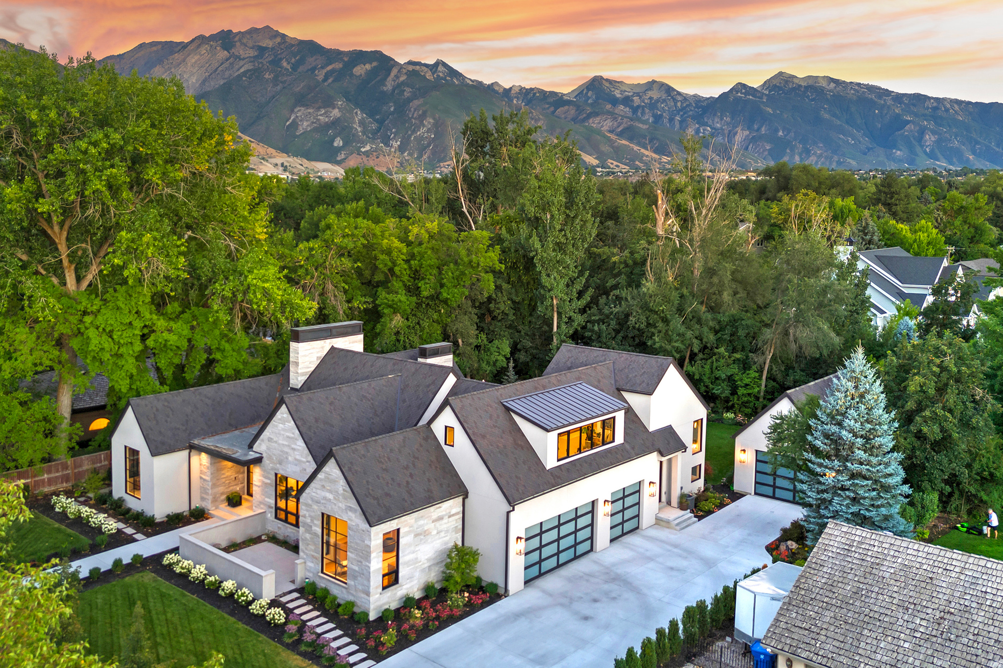 Nestled in the heart of a serene and private Holladay location on a picturesque 1/2ac lot, surrounded by mature trees, and a tranquil stream, this exceptional newly built residence offers a rare blend of luxury, craftsmanship, and serenity. Incredible main floor living complete w/White Oak flooring, custom cabinetry, and expansive windows create a warm yet sophisticated atmosphere throughout. The stunning chef's kitchen is anchored by a 15-foot island and appointed with premier Wolf appliances, including an induction cooktop and double ovens, along with dual refrigerator drawers, an ice maker, and an impressive walk-in pantry-perfect for both everyday living and effortless entertaining. An oversized main floor primary plus two additional main floor rooms, flex space for office or additional laundry, a wall size sliding door system to seamlessly incorporate indoor/outdoor living onto the huge covered porch. A versatile upper-level suite provides flexible space for a guest retreat, additional bedroom, or playroom. The beautifully finished lower level features a beautiful workout gym, plush wool carpeting, a fireplace, golf simulator, and an elegant wet bar equipped with Sub-Zero appliances. Rarely does a new construction home offer such an extraordinary combination of refined design, modern amenities, and natural beauty-all in the prestigious Cottonwoods most coveted settings.  All info deemed reliable but not guaranteed.  Buyer to verify all. Some photos have AI enhanced staging.