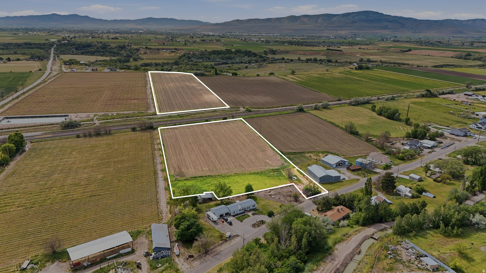 Expansive 5.39-acre property offering both space and opportunity. Zoned R2, the parcel allows for one home per 2 acres. The property includes water shares through the Bear River Canal District, adding convenience and functionality for agricultural use or animals. A Semi adjacent 14 acres is also listed. Photos show both the 5.39 Acre parcel and 14 Acre Parcel.
