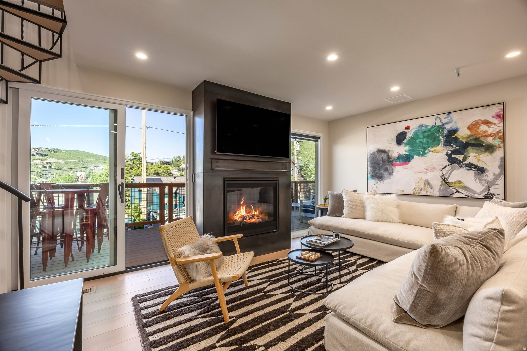 Quittin Time #441 has been fully reimagined, not just renovated. Backing directly to the slopes of Park City Mountain Resort - one of the largest ski resorts in the US - this Old Town condo offers ski-in/ski-out access with upscale craftsmanship and smart home finishes. The 2026 renovation was built from the inside out: all-new electrical, plumbing, HVAC, smart home infrastructure and security system, finished with white oak floors, electric radiant heat in the tile bathrooms, and Toto bidet toilets. Plus, a classic spiral staircase leads to the loft bunkroom above. The open living space is anchored by a floor-to-ceiling steel fireplace opening to a large deck with eastern mountain views, perfect for aprs-ski evenings and summer entertaining. Sonos speakers run through every room - kitchen to loft - while the full Apple Home system manages lighting, radiant heat, thermostat, cameras, locks, garage door, shades, and water sensors, seamlessly from your phone or voice. The private one car garage was rebuilt with the same intention: epoxy floors, level 5 drywall, ski storage, heat, hose bib, and a smart opener. Radiant heat at the driveway handles the snow, and adds a second coveted Old Town parking space. HOA dues are low (something that's hard to find!) for what this property delivers. Offered furnished, steps from Historic Main Street, and 45 minutes from Salt Lake City International, this is how you want to be living in Park City, Utah.