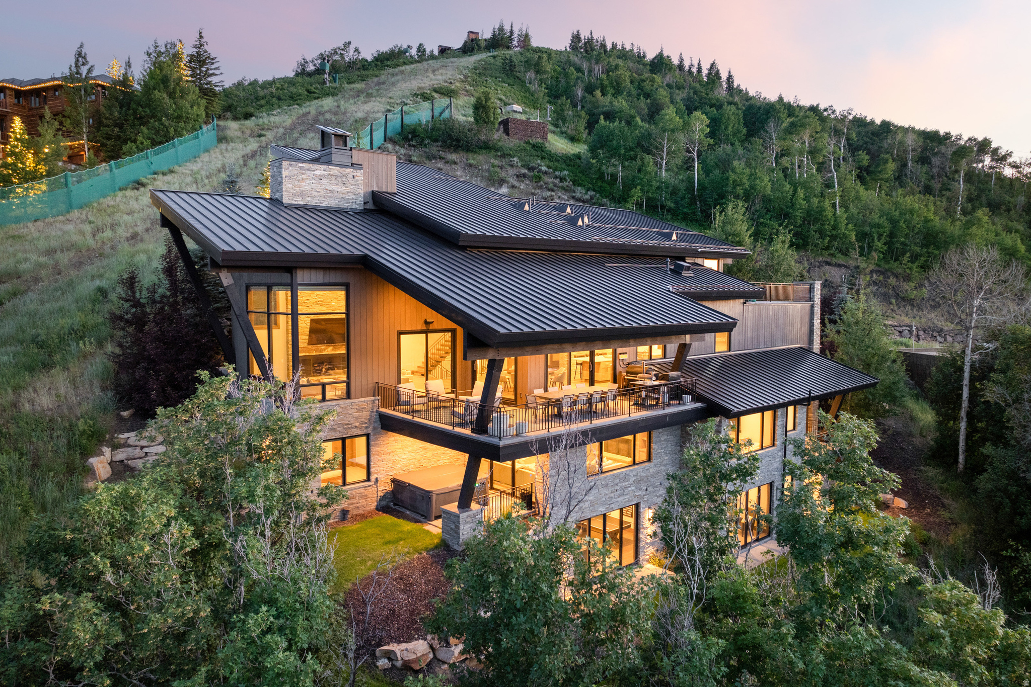 Perched on the slopes of Deer Valley Resort within the gated community of Deer Crest Estates, this architectural masterpiece sits above the new East Village expansion and offers unparalleled ski-in/ski-out access for the ultimate alpine experience. Designed with sophistication and comfort in mind, the 9,202 sq ft retreat captures breathtaking vistas of the Jordanelle Reservoir and surrounding peaks through soaring windows and expansive heated terraces. Thoughtfully appointed with six ensuite bedrooms, multiple gathering spaces, a private ski prep lounge, and a state-of-the-art media room, the home is ideal for both grand entertaining and quiet family moments. The primary suite occupies its own level, featuring a spa-inspired bath and a private balcony to take in the mountain air.