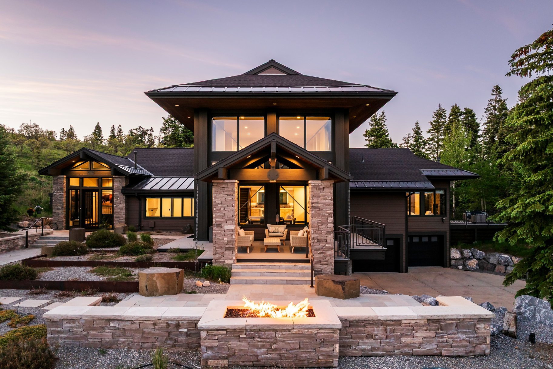Perched atop a spectacular mountain view lot, this recently updated 5-bedroom retreat offers a rare combination of privacy, convenient access to Park City's world-class recreational amenities, and commanding views of the Wasatch Back and the Uinta Mountains. Set within the gated community of Red Hawk Ranch in Silver Creek, a 425-acre wildlife preserve comprised of only 23 homesites, the property enjoys a peaceful, private setting surrounded by open space, abundant wildlife, and breathtaking 270-degree views. Expansive windows frame views from nearly every room, contemporary finishes, hardwood and concrete flooring, sauna, hot tub and an expansive climate-controlled wine cellar create an elevated living experience. A 520-square-foot apartment or guest suite with a full kitchen provides flexibility for visiting family and friends, multigenerational living, or a private home office. Outdoor living with multiple patios and gathering spaces is designed for Utah's four-season lifestyle. Enjoy morning coffee as the sun rises over the mountains, entertain in the fall beneath overhead patio heaters, unwind in the hot tub after a day on the slopes, or relax beside one of two outdoor fire pits while taking in unforgettable sunsets. A private sauna offers the perfect place to recharge after skiing, mountain biking or hiking nearby. Residents enjoy fully paved roads, gated access, and a quiet environment where snowmobiles and ATVs are prohibited, preserving the community's natural character. elk, moose, deer, hawks, wild turkeys, and other wildlife are regularly seen, providing an authentic mountain living experience. The community allows a barn on each lot and horses with HOA approval. The property is just minutes from Park City's endless recreation and 15 minutes from Whole Foods, Smiths, restaurants, shopping, and everyday conveniences. This is a rare opportunity to own a private mountain sanctuary.