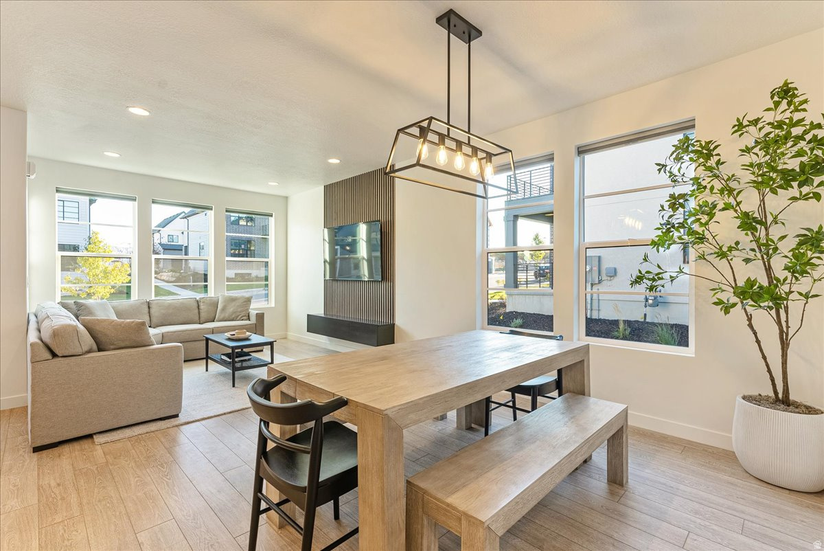 IMPROVED PRICING AND $5000 SELLER CONCESSIONS!!! Tucked in the heart of Lehi - recently named one of the best small cities to live in the U.S. This immaculate Scandinavian-style home blends modern design with everyday comfort. The minimalist aesthetic is paired with beautiful upgraded lighting and hardware, creating a space that feels both stylish and welcoming. Inside, you'll find three spacious bedrooms, a big loft, custom accent walls throughout  that add character, and an unfinished basement ready for your personal touch. The home also includes a water softener and epoxy garage flooring for durability and easy upkeep. You'll also appreciate the thoughtful upgrades throughout, including high-end custom blinds that elevate both style and privacy. The kitchen and laundry are move-in ready with a refrigerator, washer, and dryer, all purchased in 2024, adding convenience and value from day one. Location is a major highlight, you're just minutes from Traverse Mountain with its shopping and outlets, and about the same distance to Costco and Harmons Grocery. A new Smith's Food and Drug is also currently being built just a couple of minutes away, adding even more convenience. Commuting is easy with quick access to Mountain View Corridor (SR-85) just moments from the home, offering a direct route toward Salt Lake City. You're also about 10 minutes from Interstate 15 (Veterans Memorial Highway), making travel north to Salt Lake or south toward Las Vegas simple and convenient. Even better, the HOA takes care of landscaping and snow removal, making maintenance simple year-round. Homeowners in the Ivory Scandinavian community also enjoy access to a private clubhouse and pool, perfect for relaxing and connecting with neighbors. If you're looking for a modern home with clean design and low-maintenance living, this one is truly special.