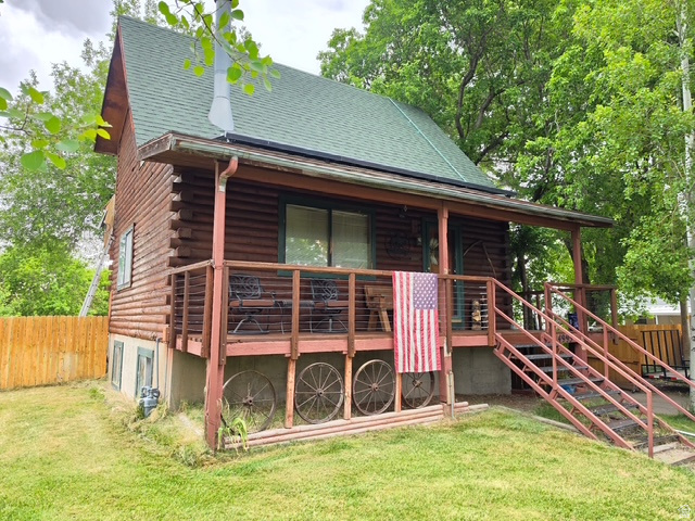 WELCOME TO YOUR OWN PRIVATE CABIN IN THE HEART OF WEBER COUNTY - Built in 1981, this well-maintained log cabin blends a cozy atmosphere with incredible outdoor versatility. Offering 3 comfortable bedrooms and 2.5 bathrooms, the property provides plenty of room to enjoy inside and out.The defining feature of this property is its massive, flat lot spanning over half an acre, providing a rare amount of space for livestock and other animals. The fully fenced, secluded yard includes mature trees, a vegetable garden space, a covered deck, and secondary water-making it perfect for outdoor entertaining, pets, or hobby farming. Enjoy striking, unobstructed views of the Wasatch Mountains right from your own backyard. Listing agent related to seller.