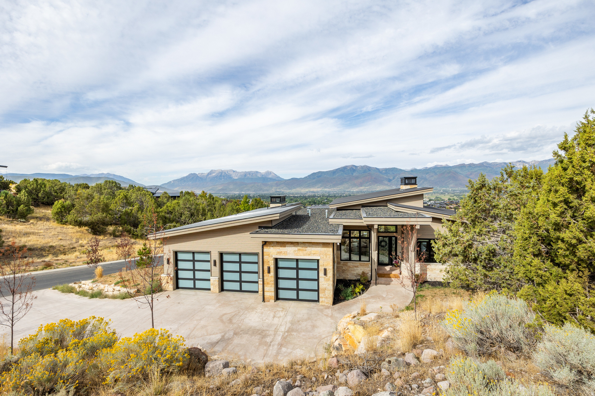 Experience contemporary mountain living in this 5,391 sq ft home tucked within the private gates of Red Ledges. Designed with clean lines and natural finishes, this residence combines modern sophistication with timeless mountain charm. The spacious layout features 5 bedrooms and 7 bathrooms, including a luxurious master suite. A gourmet kitchen with premium appliances, custom cabinetry, and an oversized island anchors the home, while the open living areas showcase soaring ceilings, and inviting spaces for gathering. Expansive outdoor living includes a covered patio, natural landscaping, and sweeping mountain views, creating the perfect setting to relax or entertain. Red Ledges residents enjoy world-class amenities, including golf, swimming, tennis, fitness, and dining, with a required Golf Park or Lifestyle membership available with this property. Ideally located just minutes from downtown Heber and within easy reach of Deer Valley world-class skiing, this home offers the ultimate blend of luxury and mountain living. Schedule your private tour today.