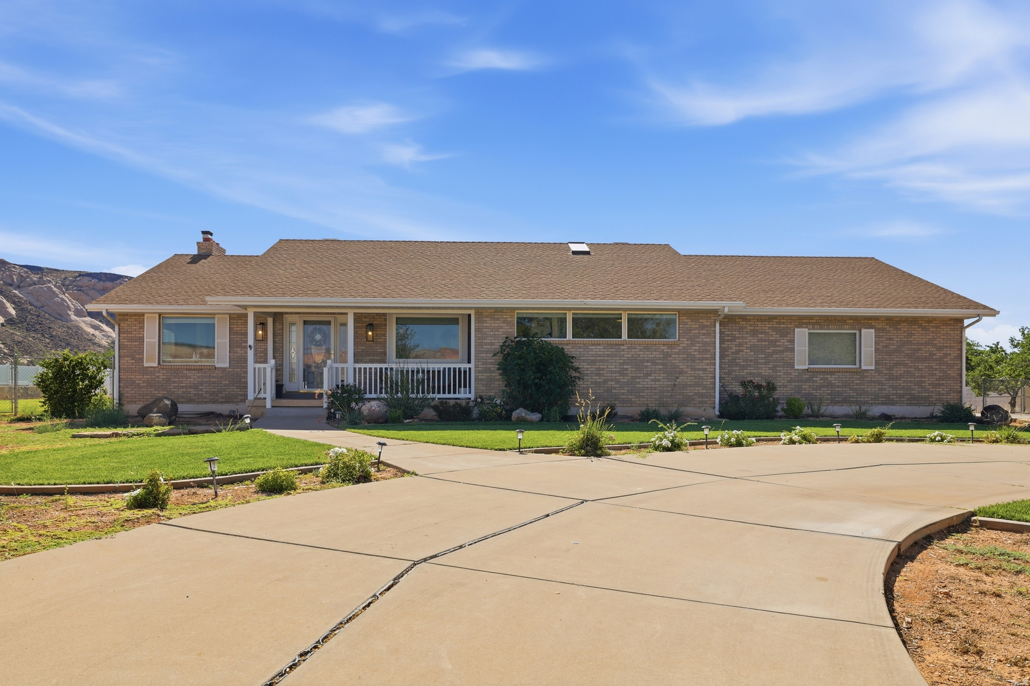 Experience the perfect blend of country living and modern comfort in this beautifully remodeled brick rambler situated on a full acre just 10 minutes from town and only minutes from stunning Snow Canyon State Park. Offering 3,454 square feet of open-concept living space, this inviting home features 4 spacious bedrooms and 3 bathrooms designed for both everyday living and entertaining.  The heart of the home showcases a bright, open floor plan with updated finishes throughout, creating a warm and welcoming atmosphere. The luxurious primary suite is a true retreat, featuring a spa-inspired bathroom designed for relaxation and comfort.  Step outside and take in the absolutely incredible views that surround this property. This property is perfectly set up for your country lifestyle. Bring your horses, chickens, goats, cows, or other animals and enjoy the freedom of acreage living without sacrificing convenience. A large chicken coop is already in place, and the impressive 28' x 36' detached garage with power provides abundant space for vehicles, equipment, toys, or a workshop.  Adventure begins right from your doorstep with direct access to horseback riding and dirt bike trails.