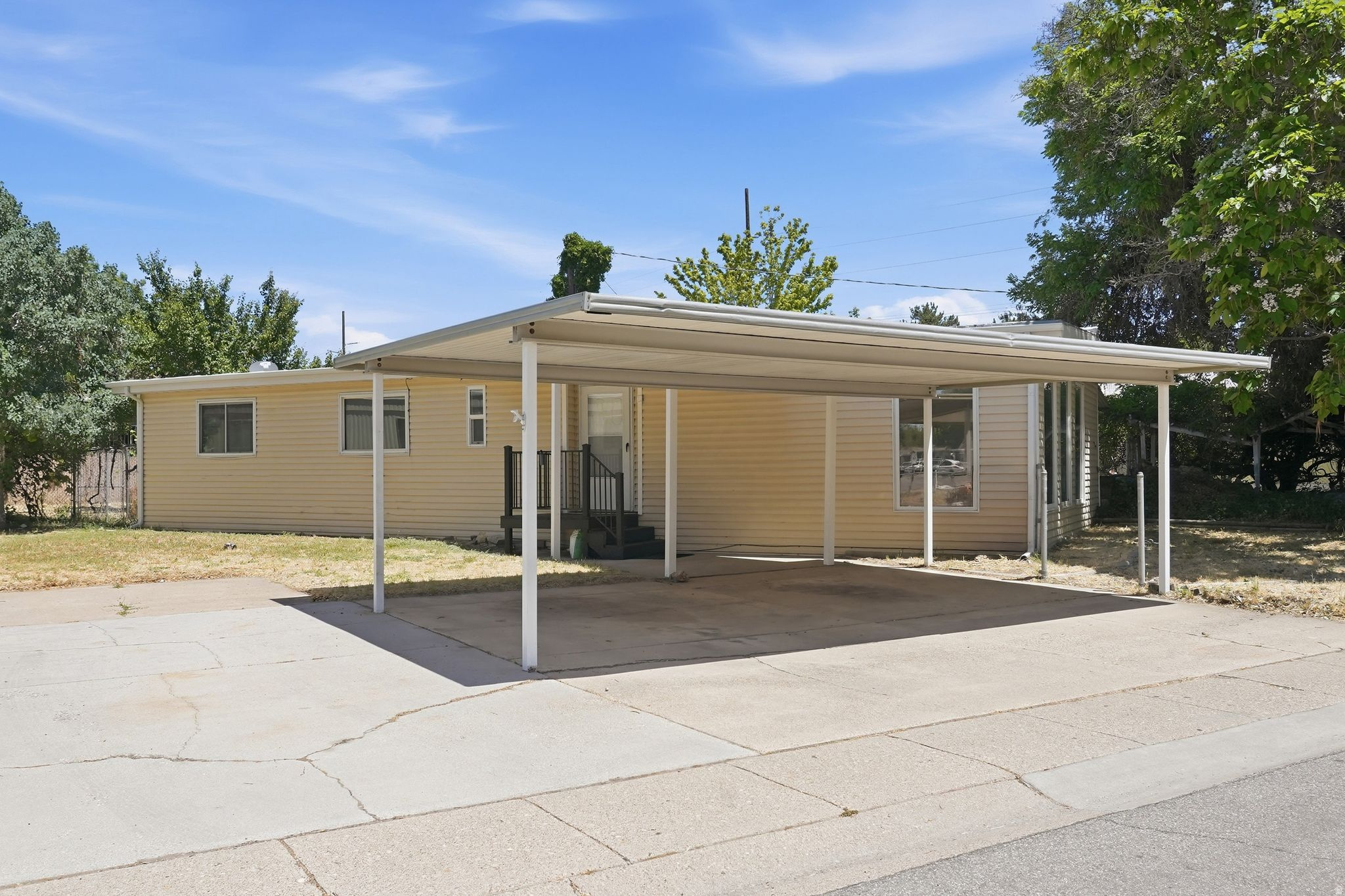 Welcome to your dream home in Clearfield highly desirable Sundown Community! Located in a private and peaceful community, this home keeps you close to schools, parks, restaurants, shopping, and easy freeway access. This fully updated, 1,392 square foot doublewide offers the perfect blend of modern style and spacious comfort. Step inside to a bright, open living space featuring fresh paint, brand new light fixtures, and elegant French doors. The gorgeous updated kitchen comes fully loaded with a gas range and a premium smart refrigerator with a built in screen, plus the washer and dryer are included! With 3 spacious bedrooms and 2 full bathrooms, including a primary suite with a generous walk in closet, this home is completely move in ready. Stay cool all summer with central air conditioning. Outside, you will enjoy one of the largest premium lots in the entire community, complete with a covered patio, partial fence, wide carport, and dedicated space for your RV. Need extra storage or hobby space? You will love the two outdoor sheds, including one already set up as a workshop. Incredible value, unmatched features, and a prime location. Schedule your private tour today before it is gone!