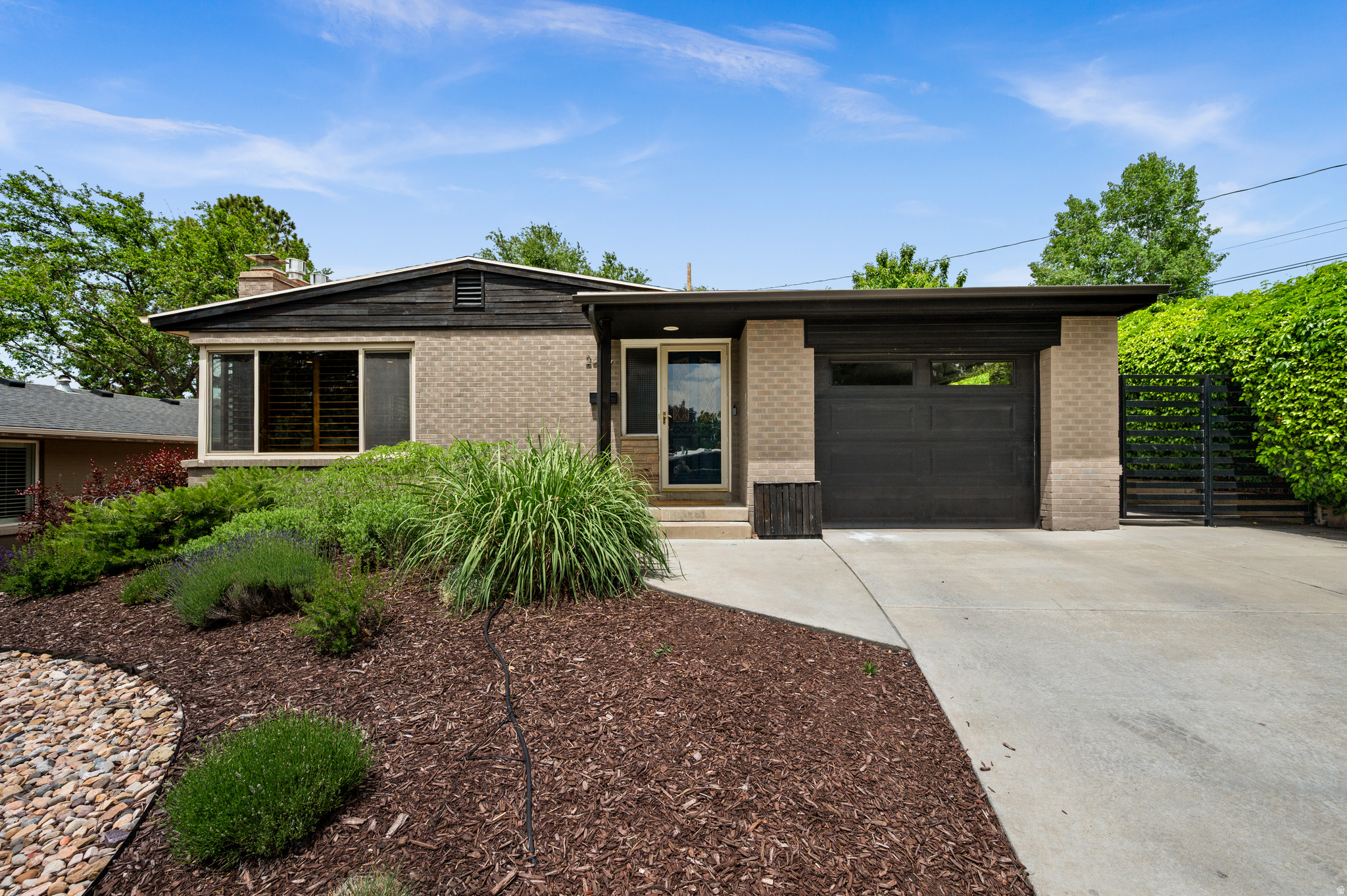 Positioned at the pinnacle of a quiet cul-de-sac on the prestigious East Bench, this residence offers a rare standard of seclusion and refined living. Originally constructed in 1953 and transformed by a comprehensive, high-caliber renovation in 2015, the home strikes a masterclass balance between mid-century architectural integrity and the seamless convenience of modern infrastructure. Spanning five bedrooms and three bathrooms, the layout is designed for the discerning homeowner. The culinary heart of the home is strategically situated between an intimate breakfast nook and a formal dining suite, flowing effortlessly into expansive living areas - an environment engineered for both high-level hosting and private relaxation. With three bedrooms on the main level and two versatile basement suites, the property offers unparalleled flexibility for a sophisticated home office, a private fitness studio, or guest accommodations. Outside, the fully landscaped and fenced grounds provide a secure, private sanctuary, completing this definitive East Bench offering. Square footage figures are provided as a courtesy estimate only and were obtained from County Records .  Buyer is advised to obtain an independent measurement.