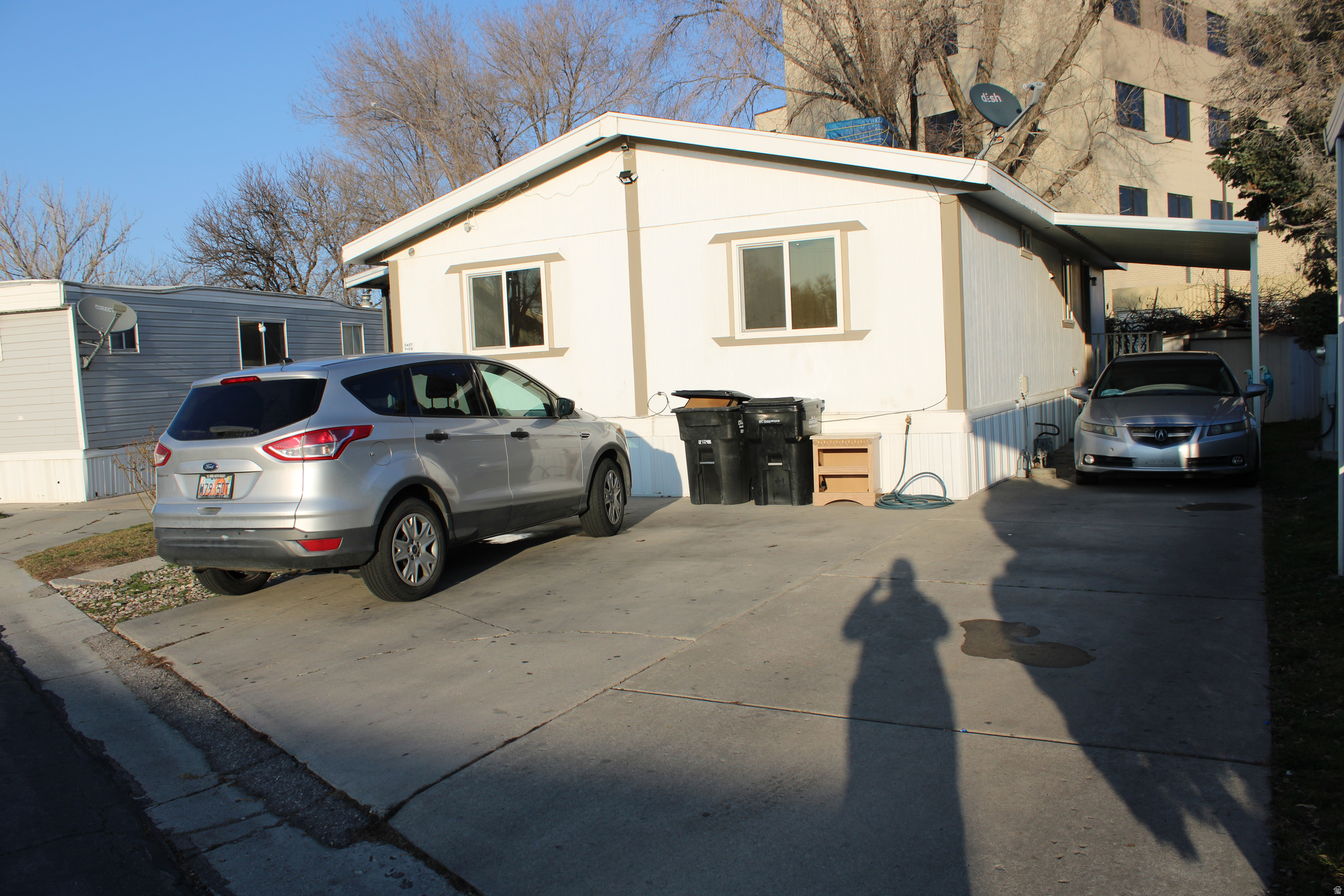 1998 Double-Wide Mobile Home located in West Valley City, in excellent condition and ideal for a first-time home buyer. The roof was replaced sometime in 2024, offering added peace of mind. Enjoy a nice and pleasant backyard with plenty of shade from mature tree. The home is conveniently located near essential services and everyday conveniences, including shopping centers, freeway access, and is within walking distance to Common Spirit Holy Cross Hospital. Community & Fees: Lot Rent: $1004.31/month / Plus Utilities: Community amenities include a swimming pool, playground, and clubhouse Buyer and buyer's agent to verify all information, including square footage.