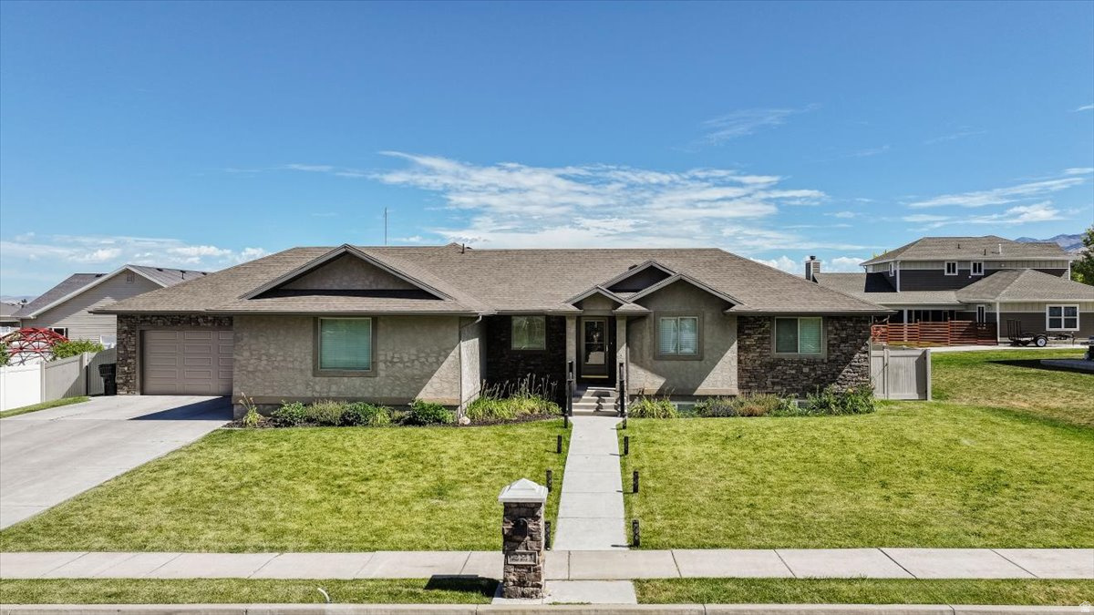 This beautifully designed 3,176-square-foot home is nestled in the peaceful community of Hyde Park, where quiet neighborhoods and breathtaking mountain views create the perfect place to call home.  Inside, you'll find 5 bedrooms, 3 bathrooms, and a thoughtfully designed floor plan perfect for everyday living and entertaining. The heart of the home is the stunning kitchen featuring a massive center island, custom two-toned alder cabinetry, abundant storage, and generous workspace that flows seamlessly into the main living area.  The spacious primary suite provides a relaxing retreat with plenty of room to unwind after a long day. Downstairs, the fully finished basement offers exceptional versatility with additional living space, bedrooms, and a dedicated office. Car enthusiasts, outdoor adventurers, and those needing extra storage will appreciate the incredible 1,267-square-foot, 3-car garage, providing ample room for vehicles, toys, tools, and workshop space.  With quality finishes, generous living spaces, and a desirable Hyde Park location, this home offers the perfect blend of comfort, functionality, and timeless style. *New schools opening for the 2026/2027 are Old Ephraim Elementary and Juniper Ridge Middle School.