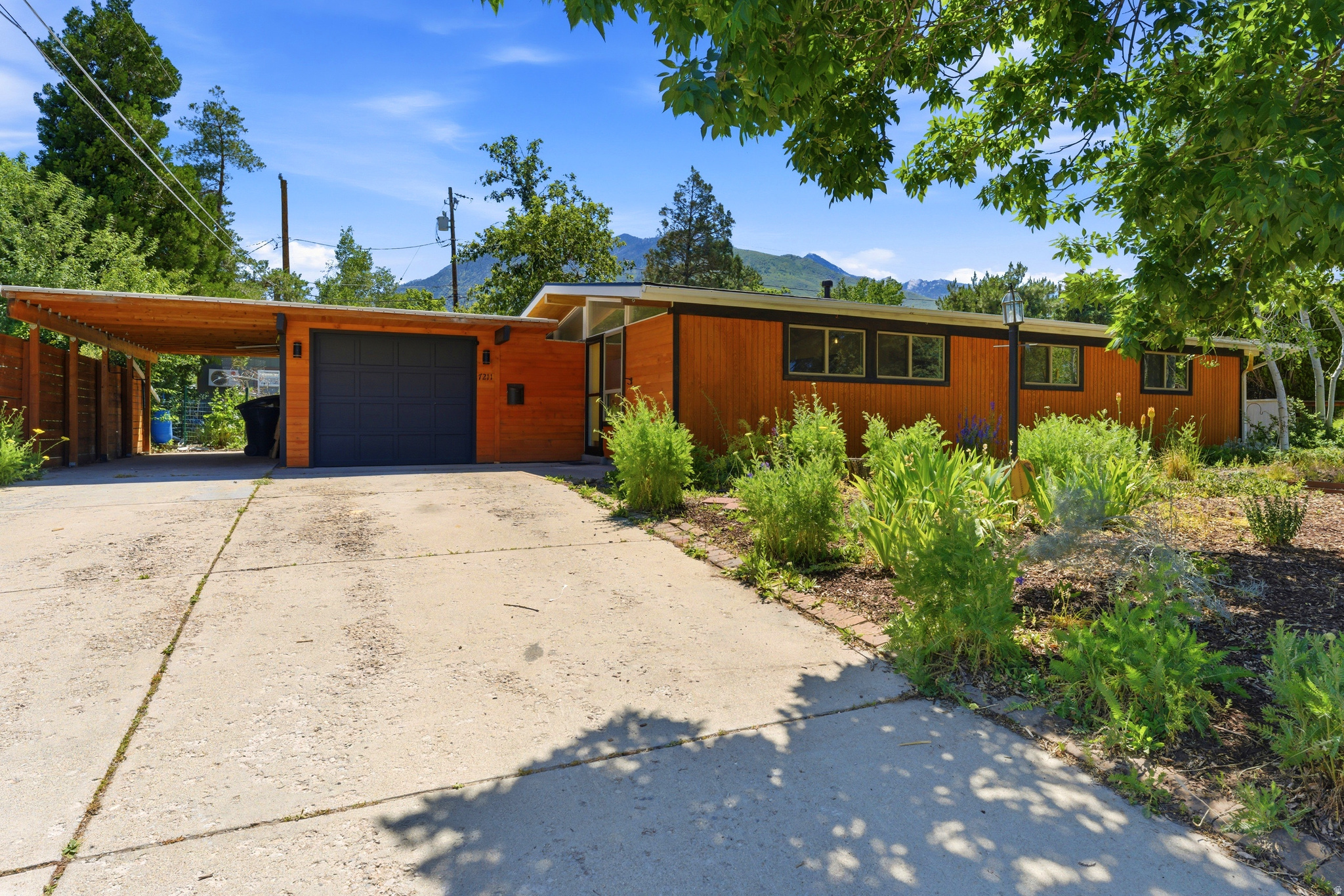 Nestled in the heart of Cottonwood Heights, this one-of-a-kind mid-century modern home blends warmth, style, and functionality in an incredible location near the canyons, world-class ski resorts, fabulous restaurants, and businesses, and 2-15. The thoughtfully xeriscaped yard is filled with native and drought-tolerant plants, flowers, berries, white grapes, and pollinator-friendly landscaping, creating a peaceful outdoor retreat. Enjoy the tranquil pond and waterfall feature, while adding your own finishing touch to the upper pond. Inside, you'll find stunning wood-paneled ceilings, eucalyptus flooring, renewable Marmoleum kitchen floors, reclaimed bowling alley butcher block countertops, and double Bosch ovens. The beautifully updated bathroom features heated tile flooring, a curbless wet-room style shower, and a Japanese soaking tub! Major updates include a new roof in 2025, new windows, and new wood siding. The spacious detached man cave/she-shed offers endless possibilities for hobbies, work, or entertaining. This is a truly special property with character, charm, and modern comfort throughout. Auto sprinklers worked when purchased but have not been used by current sellers. The upper pond is in working order, but needs to be resealed. Photography to come!