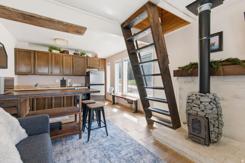 Discover the perfect mountain getaway in Brian Head! This charming studio loft condo is ideally located on the quieter end of town, just a short walk to both Chair 1 and Chair 8 for easy ski access in the winter, while also being steps from Bristlecone Pond and the park for summer recreation and events. As an end unit, this condo offers added privacy with only one shared wall and is filled with abundant natural light from its many windows. The loft creates additional sleeping space and offers exciting potential for expansion, with the opportunity to create nearly the same square footage upstairs as the main level for those looking to customize and add value. Whether you're searching for a personal mountain retreat, an investment property, or a nightly rental opportunity, this condo checks all the boxes. Even better, it features one of the lower HOA dues in all of Brian Head, helping keep ownership costs more affordable while still enjoying everything this four-season mountain destination has to offer.