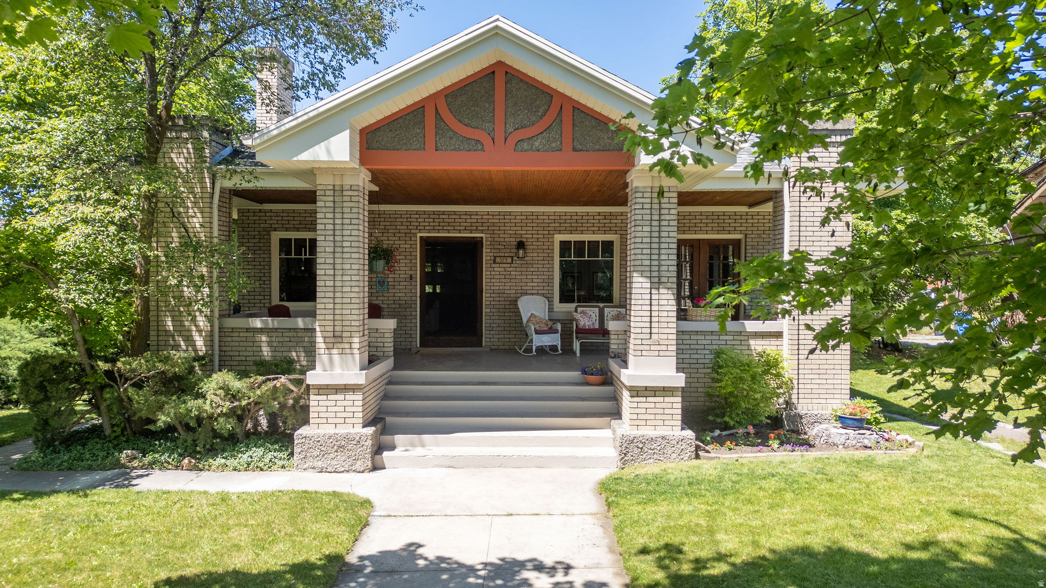 Located on one of Logan's most desired streets, this beautiful bungalow welcomes you with a gorgeous, south-facing front porch that offers incredible, unobstructed views of the valley.  The home still has original details-hardwood floors, original light fixtures, and a classic built-in china hutch. The open living spaces offer natural light through large windows and an inviting gas fireplace.  The updated kitchen features white cabinetry, quartz countertops, upgraded appliances and a charming dining area surrounded by windows.  Both bathrooms have also been updated. The property offers  a fully finished walk-out basement with ample storage and a detached 2 car garage.  Enjoy the proximity to USU, Logan Canyon, walking trails  and the shops and restaurants of downtown.  Buyer to verify all information.