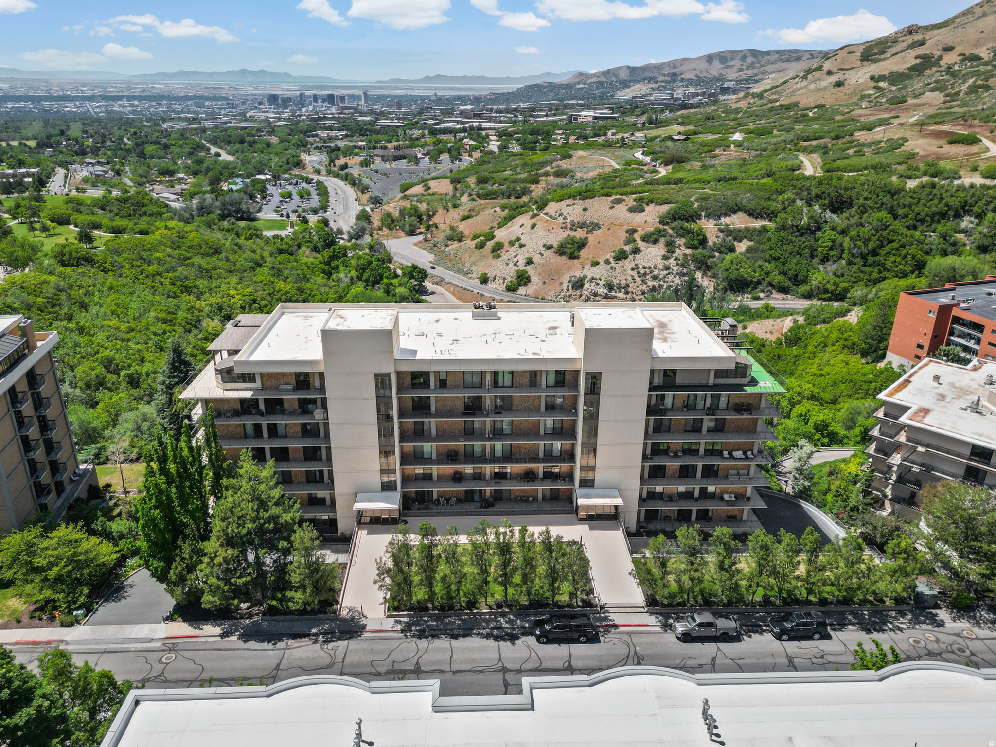 Perched on the 6th floor of the sought-after Donner Place Condominiums, this beautifully remodeled residence combines refined finishes, an open-concept design, and breathtaking panoramic views of the Salt Lake Valley, Great Salt Lake, and surrounding mountains. Thoughtfully updated to maximize both function and natural light, the spacious floor plan seamlessly connects the kitchen, dining, den, and living areas-creating an ideal setting for everyday living and entertaining.  The remodeled kitchen features custom cabinetry, granite countertops, and a generous island that opens to the main living space. Newer sliding glass doors and updated windows frame the spectacular scenery while enhancing energy efficiency and bringing the outdoors in. Step onto one of two private balconies and enjoy unforgettable sunsets, sparkling city lights, and ever-changing mountain vistas from your elevated vantage point.  Offering over 2,000 square feet of single-level living, this residence includes two spacious bedrooms, a dedicated office/den, and generous storage. Residents of Donner Place enjoy secure access, covered parking, a rare extra covered parking spot, pool and spa amenities, and an unbeatable location tucked against the foothills while remaining just minutes from downtown Salt Lake City, the University of Utah, world-class hiking and biking trails, and premier healthcare facilities.  A rare opportunity to own a move-in-ready condominium with exceptional views, modern updates, and one of the most desirable foothill locations in Salt Lake City.