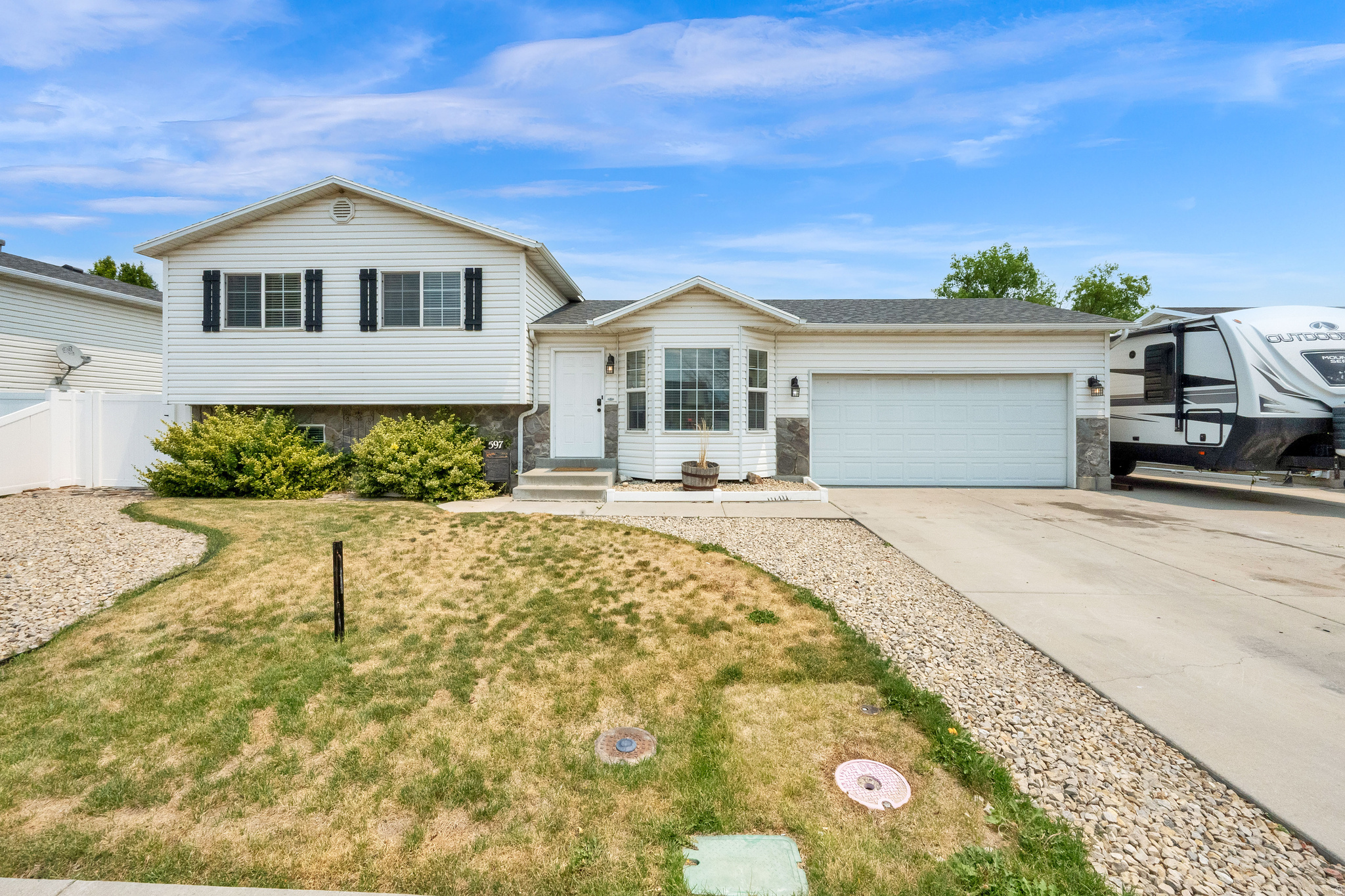 Enjoy the perfect blend of comfort and convenience in this Lehi home near Sommerset Park. Take in beautiful Mount Timpanogos views from the flagstone patio and pergola, the perfect spot for morning coffee or summer BBQs. The fully fenced yard offers space for pets, play, and entertaining. Need room for your toys and tools? The property includes an 10' x 22' shop, with an 8' x 8' overhead door, ideal for a side-by-side, plus a covered carport and additional storage shed.