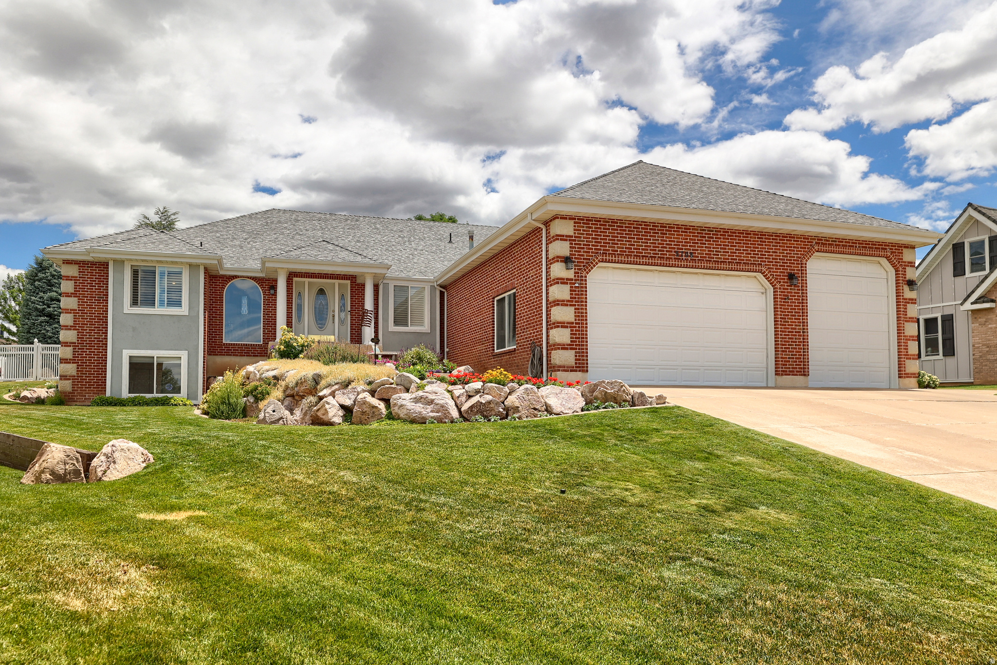 An all-brick rambler with nearly 5,000 square feet sets a substantial, timeless tone at 5708 S 950 E in South Ogden's Pleasant Valley area. From the curb to the covered patio, this home offers the kind of space, comfort, and enduring construction that make daily living feel easy and expansive in South Ogden.  Inside, 5 bedrooms and 4 baths unfold across 4,884 square feet of well-planned living space, giving each room a comfortable sense of scale. Built in 1994 and thoughtfully updated, the home features a newer roof and HVAC system for added peace of mind, along with newly finished hardwood floors that bring warmth and polish to the main living areas. The spacious kitchen is designed for gathering and everyday function, with high-end appliances, generous cabinetry, and ample counter space overlooking the living and dining areas. A private primary suite offers an oversized bath with premium fixtures, a soaking tub, and a spacious walk-in shower, while the expansive floor plan creates room to relax, host, work, and spread out with ease.  Outdoors, the covered patio extends the living space into a private fenced yard accented by mature fruit trees, creating a calm backdrop for morning coffee, evening meals, or weekend time outside. An oversized 3-car garage adds valuable space for vehicles, storage, and hobbies, and optional furnishings may be available for a smoother transition. Close to South Ogden parks, shopping, dining, and everyday conveniences, this South Ogden home brings together generous scale, thoughtful updates, and a setting that feels connected yet tucked away. Schedule a private tour and experience the space in person.