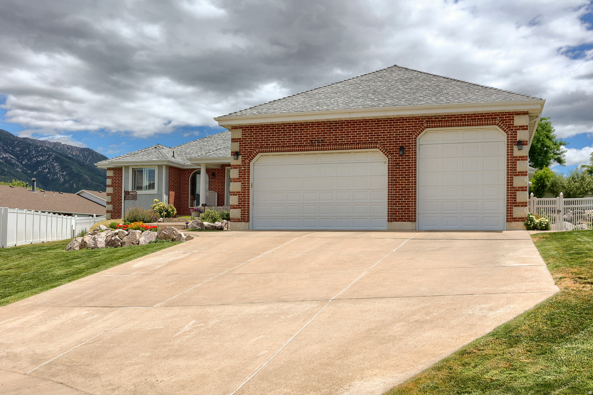 An all-brick rambler with nearly 5,000 square feet sets a substantial, timeless tone at 5708 S 950 E in South Ogden's Pleasant Valley area. From the curb to the covered patio, this home offers the kind of space, comfort, and enduring construction that make daily living feel easy and expansive in South Ogden.  Inside, 5 bedrooms and 4 baths unfold across 4,884 square feet of well-planned living space, giving each room a comfortable sense of scale. Built in 1994 and thoughtfully updated, the home features a newer roof and HVAC system for added peace of mind, along with newly finished hardwood floors that bring warmth and polish to the main living areas. The spacious kitchen is designed for gathering and everyday function, with high-end appliances, generous cabinetry, and ample counter space overlooking the living and dining areas. A private primary suite offers an oversized bath with premium fixtures, a soaking tub, and a spacious walk-in shower, while the expansive floor plan creates room to relax, host, work, and spread out with ease.  Outdoors, the covered patio extends the living space into a private fenced yard accented by mature fruit trees, creating a calm backdrop for morning coffee, evening meals, or weekend time outside. An oversized 3-car garage adds valuable space for vehicles, storage, and hobbies, and optional furnishings may be available for a smoother transition. Close to South Ogden parks, shopping, dining, and everyday conveniences, this South Ogden home brings together generous scale, thoughtful updates, and a setting that feels connected yet tucked away. Schedule a private tour and experience the space in person.