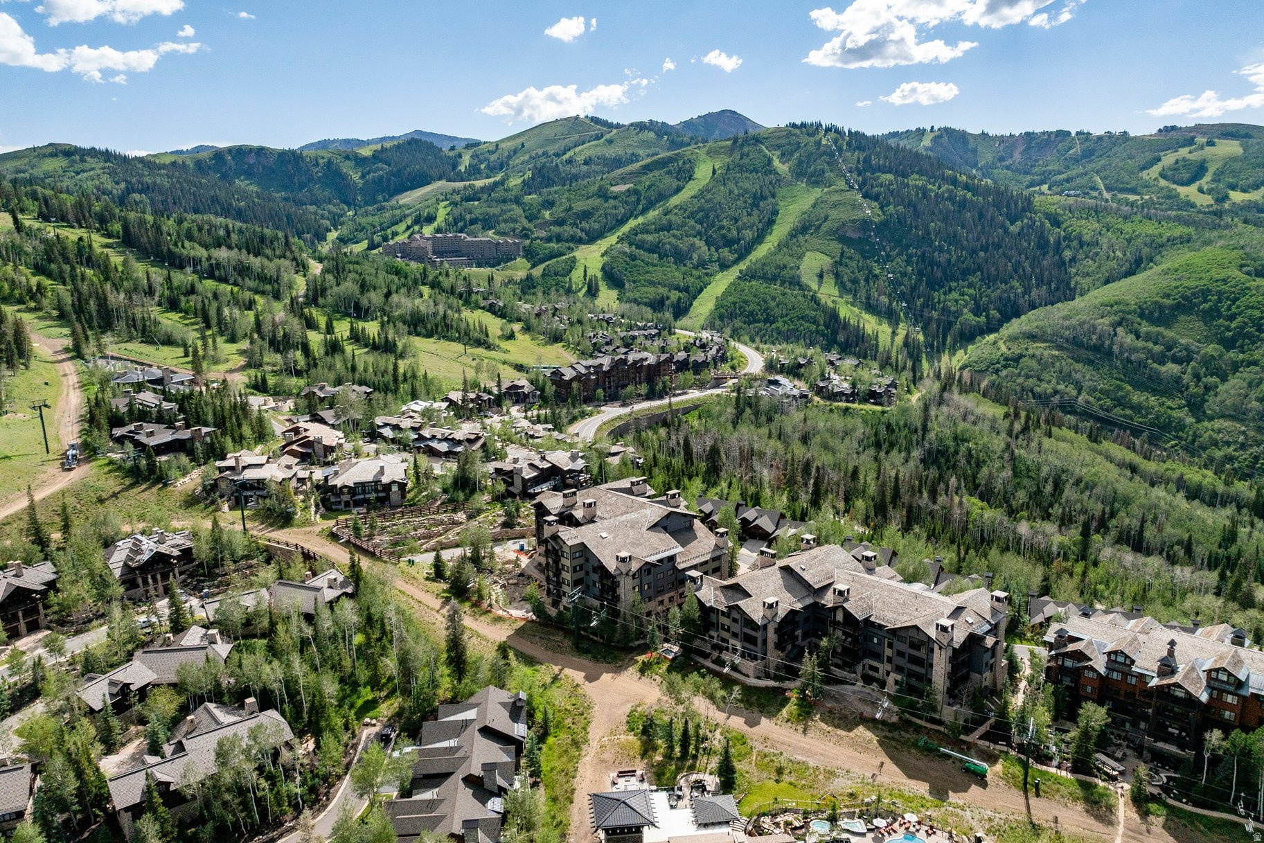 Set within one of Deer Valley 's most picturesque and convenient locations, the exclusive Arrowleaf Condominiums in Empire Pass define an exceptional mountain lifestyle with easy year-round access to mountain amenities. Just steps from the Talisker Club's Tower Club, Silver Buck ski trail, and Silver Strike chairlift, this coveted mid-mountain location allows owners and guests to enjoy effortless access to First Tracks skiing, well ahead of lower-mountain traffic.  Upon entering, guests are captivated by the property's breathtaking views toward Lady Morgan bowl. Designed for maximum comfort and refined mountain luxury, the expansive great room features high ceilings, a floor-to-ceiling stone fireplace, and a wall of windows that frame unobstructed western vistas. A spacious balcony off the great room provides the perfect setting for relaxing any time of day and taking in the spectacular night sky.  The open-concept kitchen and dining area is ideal for both entertaining and everyday living, offering bar seating and a 62-inch round dining table to accommodate up to eight guests. The gourmet kitchen is equipped with granite countertops and premium stainless steel appliances, including a wine refrigerator with the layout allowing the chef to remain connected with family and friends.  The primary suite is a private retreat with views to the ski slopes, a generous walk-in closet and a luxurious ensuite bath with jetted tub and oversized walk-in shower. Two additional bedrooms, one a bunk room, each feature ensuite baths and provide flexible accommodations for family and guests. For the buyer's convenience the property is being sold furnished and includes locked owners closets throughout the condominium.  Additional features include onsite management, ski-lockers, fitness room, plentiful storage, heated garage. The HOA's complimentary shuttle service provides convenient transportation to Deer Valley amenities and Park City for dining, shopping, and entertainment.