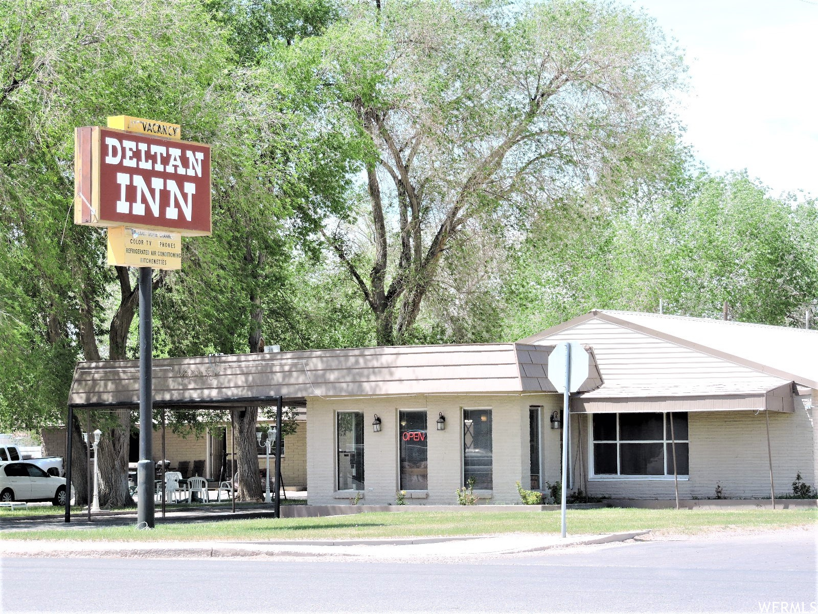 This well-known motel has served travelers visiting Delta for many years and continues to be a welcoming stop for guests exploring the area. Located on Main Street with excellent visibility, the property is conveniently within walking distance to restaurants, shopping, bowling, a movie theater, and local museums. Adventure seekers will appreciate the close proximity to the famous Little Sahara Recreation Area, just about 40 minutes away, where visitors enjoy sand dunes, rock hounding, camping, and a variety of outdoor activities. After a day of adventure, guests return to the comfort and convenience this motel provides. The property includes a reception area and 15 guest units, with a combination of single and double rooms. Some rooms have already been extensively renovated, with additional updates underway. Guests can enjoy a shaded grassy area with a patio, and plenty of parking. A digital advertising sign provides excellent exposure along the Main Street corridor. Also included is a spacious 1,716 sq. ft. owner/manager home, currently operating as an Airbnb, featuring 3 bedrooms, 2 bathrooms, a living room, and a large family room, offering additional income potential or comfortable on-site living.