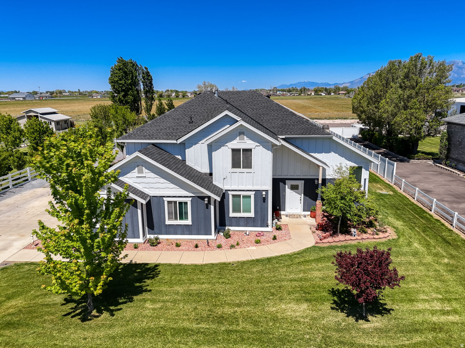 Rare horse property opportunity in desirable Hooper! Situated on 1.03 acres, this spacious 2-story home offers 3,122 sq ft with 5 bedrooms, 3 bathrooms, and the highly sought-after feature of dual master suites, providing flexible living arrangements for multi-generational living, guests, or expanded household needs.  The home has seen numerous major updates including a new roof, new siding, fresh interior paint, updated flooring, and dual HVAC systems featuring 2 furnaces and 2 condensers for enhanced comfort and efficiency throughout the home.  Outside, the property offers the space and functionality horse-property buyers are looking for, along with mature fruit trees that add beauty, shade, and seasonal harvests. Included with the property is an owned 1/2 share of irrigation water, providing added value and practical utility for maintaining the acreage, landscaping, or pasture areas.  With ample space both inside and out, this property offers endless potential for animals, recreational vehicles, gardening, outdoor entertaining, or simply enjoying the privacy and open feel of country living while still being conveniently located near schools, shopping, and commuter access.  Don't miss this rare opportunity to own updated acreage property with valuable irrigation water rights in one of Weber County's most desirable rural communities.