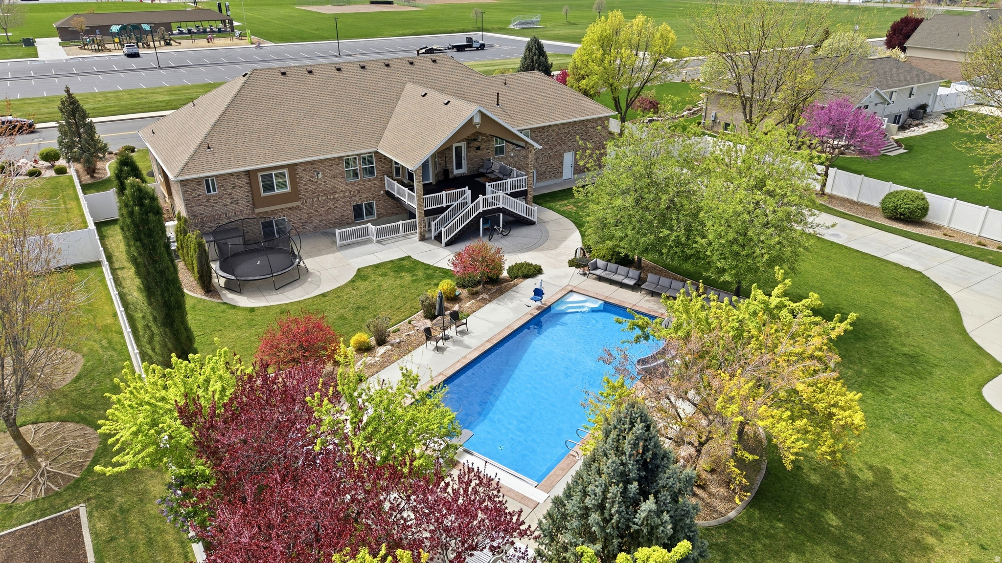 As you pull up in front of the house you notice the beautiful colors blossoming in the beautifully designed yard. You also notice the large park across the street. You continue up the wide stairs to the front door and enter the welcoming entry of your next Home! This well kept Home has so much to offer whether you are looking for a great place for multigenerational living or your own getaway from the world. The open Kitchen, great room, primary suite and office areas were redone in 2020 along with the HVAC systems, water heaters and the roof on the house and shop! The upstairs kitchen has Maple Cabinets, double wall ovens, countertop stove with decorative hood, 2-tier island with suspended chairs and an 18' vaulted ceiling. Another added convenience is the floor receptacles for the central vacuum system. The large primary Suite features a double door entry, trey ceiling with ambient lighting, walkout to the covered deck, 2 way fireplace, separate tub and shower, double vanity and large walk-in closet. The laundry room is set up for 2 dryers if needed. The basement aside from the 4 bedrooms, 1 full bathroom and full kitchen also has a theater, laundry hookups, storage room and walkout to the backyard. Could easily be a Mother-In-Law apartment. Now things are getting even more exciting! The backyard is where you find the 20x40 heated in-ground salt water pool with a diving board, slide, plenty of seating and privacy with thoughtful placement of trees. You still have plenty of grass space for activities and you can't miss the large detached garage. The garage is 50x40 with 2, 12' doors, is heated, has it's own water heater, laundry area, a 3/4 bathroom, workbench and 3 indoor/outdoor dog runs. Each garage has a 220 outlet for tools or EV charging. The long driveway to the back shop allows for lots of parking for RV's and toys and you even have sewer access for emptying the RV after a fun trip. No need to go find one and wait in line. This is truly one you have to see in person a few times and you will still miss some of the great features. So much thought has gone into functionality both inside and out! Make your appointment as soon as you can because this is one you do not want to miss! Square footage figures are provided as a courtesy estimate only and were obtained from County records.  Buyer is advised to obtain an independent measurement.