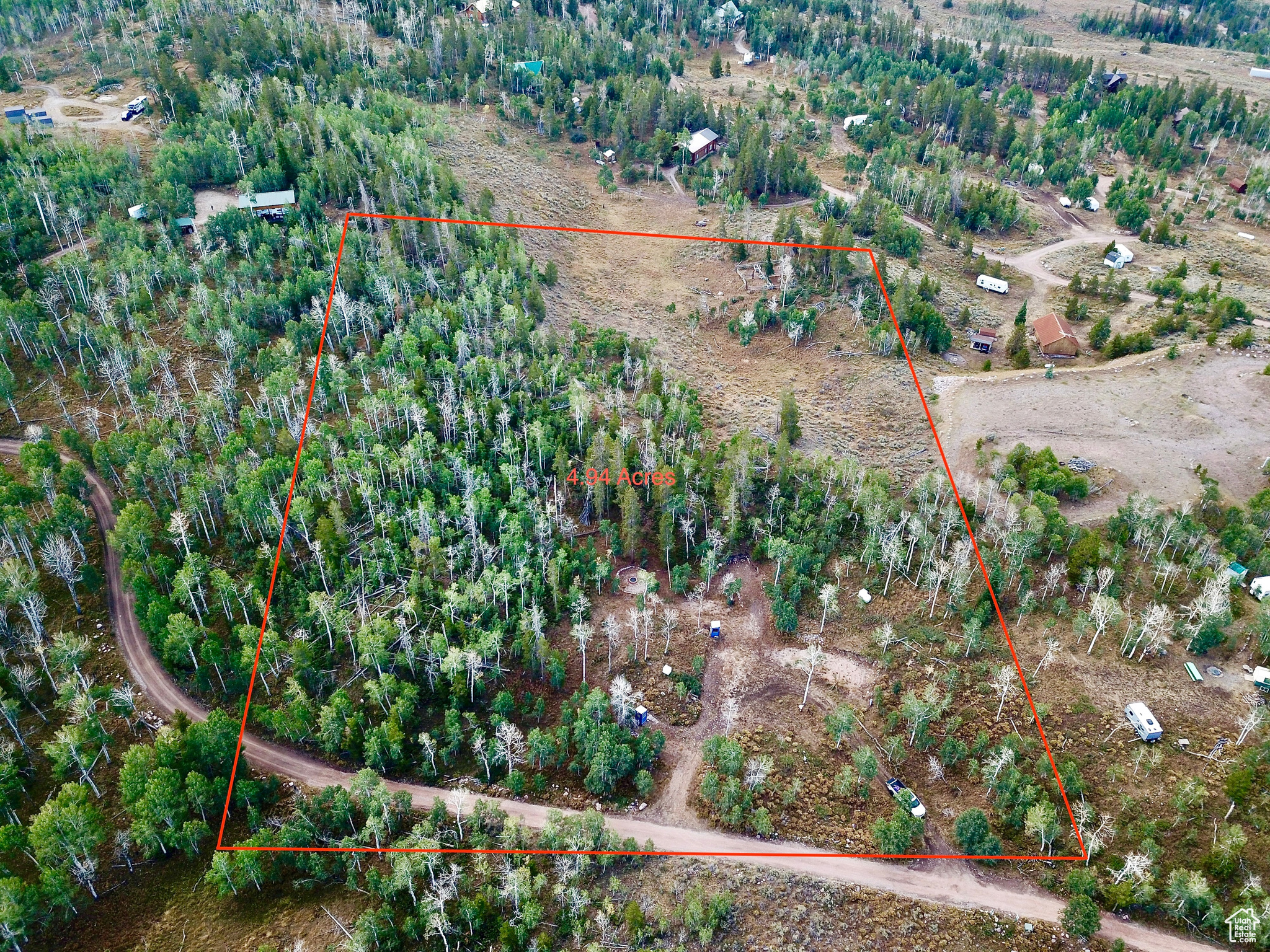 Discover the perfect blend of nature and convenience with this stunning property in the Manor Lands development. Offering a unique mix of flat usable acreage alongside beautiful hilly terrain, this land features gorgeous quaking aspens and majestic pine trees, creating a picturesque setting for your dream getaway. Ideally located just inside the entrance of Manor Land, you'll enjoy quick access to the main paved road, Mirror Lake Highway, while still reveling in the tranquility and privacy this property provides. The site comes equipped with power already run to three designated trailer sites, making it easy to set up your RV or begin building your dream cabin. Imagine evenings by the campfire in your dedicated seating area, surrounded by breathtaking views and the sounds of nature. The property also includes three separate power hookups for RVs and a covered, enclosed outhouse already on site. Plus, you'll still have reliable cell phone coverage to stay connected. Don't miss out on this incredible opportunity to own a piece of serene paradise with all the amenities you need to make it your own!