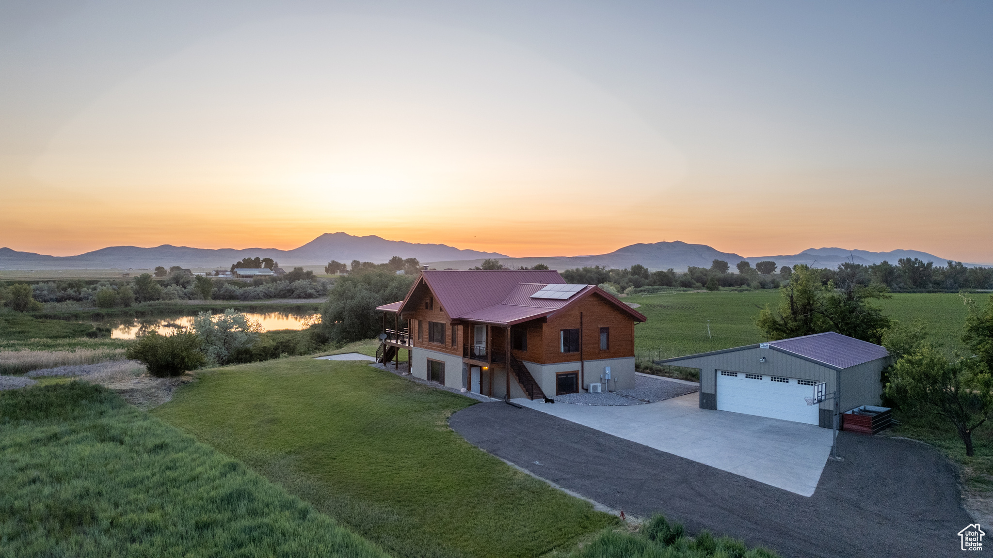 Just 15 minutes from downtown Logan, this contemporary flat cedar log home welcomes you with breathtaking 360 views before you even step inside. Nestled on 3 private acres, the setting is unmatched-surrounded by open farm fields to the north and south, the Bear River bottomlands to the west, and views of the Bear River Range to the east. Inside, the main floor features an open-concept formal family room, dining area, and kitchen-all framed by soaring ceilings and rustic-modern charm. You'll also find a laundry room, half bath, and a den with loft access that overlooks the living and dining spaces. The spacious primary suite offers a true retreat, featuring serene views, a clawfoot tub, dual walk-in closets, and a beautifully tiled shower. The daylight basement provides a separate entrance and includes a large family room, four additional bedrooms, a full bathroom, and two generous storage areas. Outside, enjoy a detached 2-car garage, ample guest parking, and room to explore or expand. Whether you're watching wildlife, enjoying radiant heat through the floors, or relaxing with energy-efficient amenities this home blends rustic elegance with sustainable design. Verify all information.