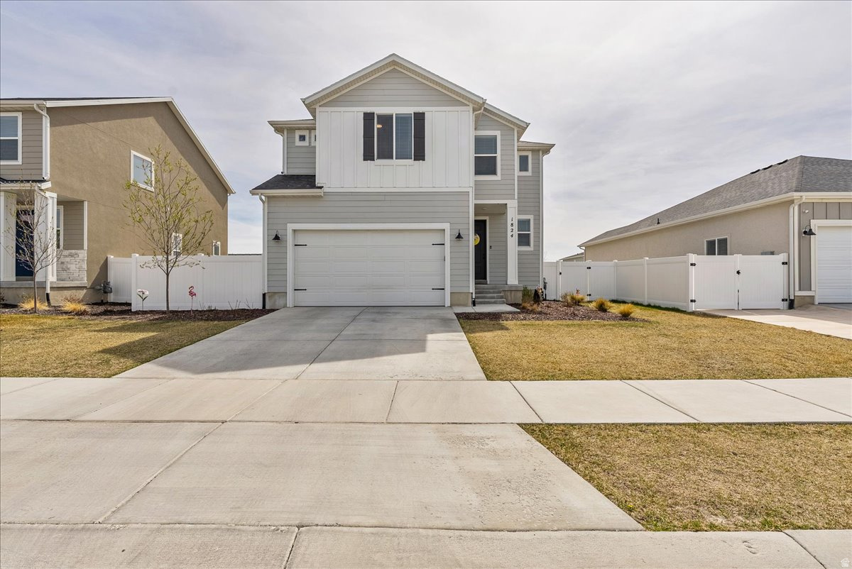 This charming two-story home has so much to love! The Kitchen features two-tone cabinetry, quartz countertops, a big island with bar seating, and stainless appliances that all come together in a space that's as beautiful as it is functional. The living room is bright and spacious with plenty of windows, recessed lighting, and a sliding door that leads out back great for letting in that Utah sunshine. The main floor also has a handy powder bath tucked away right where you need it. Upstairs you'll find the primary suite with vaulted ceilings and its own en suite, plus additional bedrooms. The loft area gives extra flexible space perfect for a home office, or reading nook. Outside, is fully fenced & wraps the backyard for privacy. This one checks all the boxes come see for yourself!