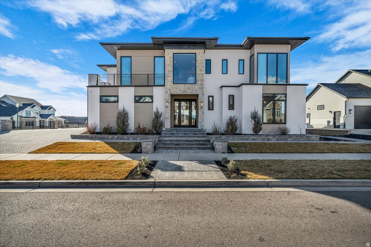 11,576 Sq Ft Estate in Orem From the dramatic four-car paver driveway to the crown jewel rooftop terrace with panoramic Wasatch Mountain views, every detail has been conceived without compromise. Situated with easy access to the freeway, universities, and everything Utah County has to offer.   Over $1 million in recent renovations by Shelby Custom Homes and designer Whitney Sukhan transformed this home from top to  bottom - new windows, hand-applied stucco, premium siding, custom cabinetry, wrought-iron railings, a plaster fireplace surround, new hardwood flooring, designer lighting in every room,  and 49 motorized window treatments with wall-mounted controls.    The Rooftop - An expansive terrace with a fully waterproofed deck system, furnished with lounge seating, dining for eight, and unobstructed 360-degree views: Spanish Fork Canyon, Alpine, Utah Lake, and the Wasatch Range. The kind of space that stops guests mid-sentence.    Main Level - Soaring vaulted ceilings, floor-to-ceiling windows, a statement fireplace with hand-finished plaster surround, and a chefs kitchen with SubZero and Wolf appliances and a full butlers pantry. Smart home automation controls lighting, shades, audio, and security across every level. Upper Level - Master suite with two walk-in closets, spa-caliber bathroom, private fireplace, and panoramic views. Two additional en-suite bedrooms and main laundry.   Lower Level - Home theater with Epson 4K projector, full basketball gym, weight room, wet bar, indoor entertaining area with grilling, designer lounge, and two more en-suite bedrooms. 8-zone whole-home audio puts music in every room and outside. The lower level alone would be the highlight of most homes.   Outdoor Living - Over $112,000 in professional landscaping with retaining walls and finished hardscaping. Fully fenced backyard with new turf, full front landscaping, 4K security cameras, enterprise Wi-Fi, and multiple terraces framing valley and mountain views.   Listed at $3.25M following over $1 million in documented upgrades.   For the family that wants it all in one place. Agent related to Seller. Square footage figures are provided as a courtesy estimate only and were obtained from a licensed appraiser. Buyer to verify information.